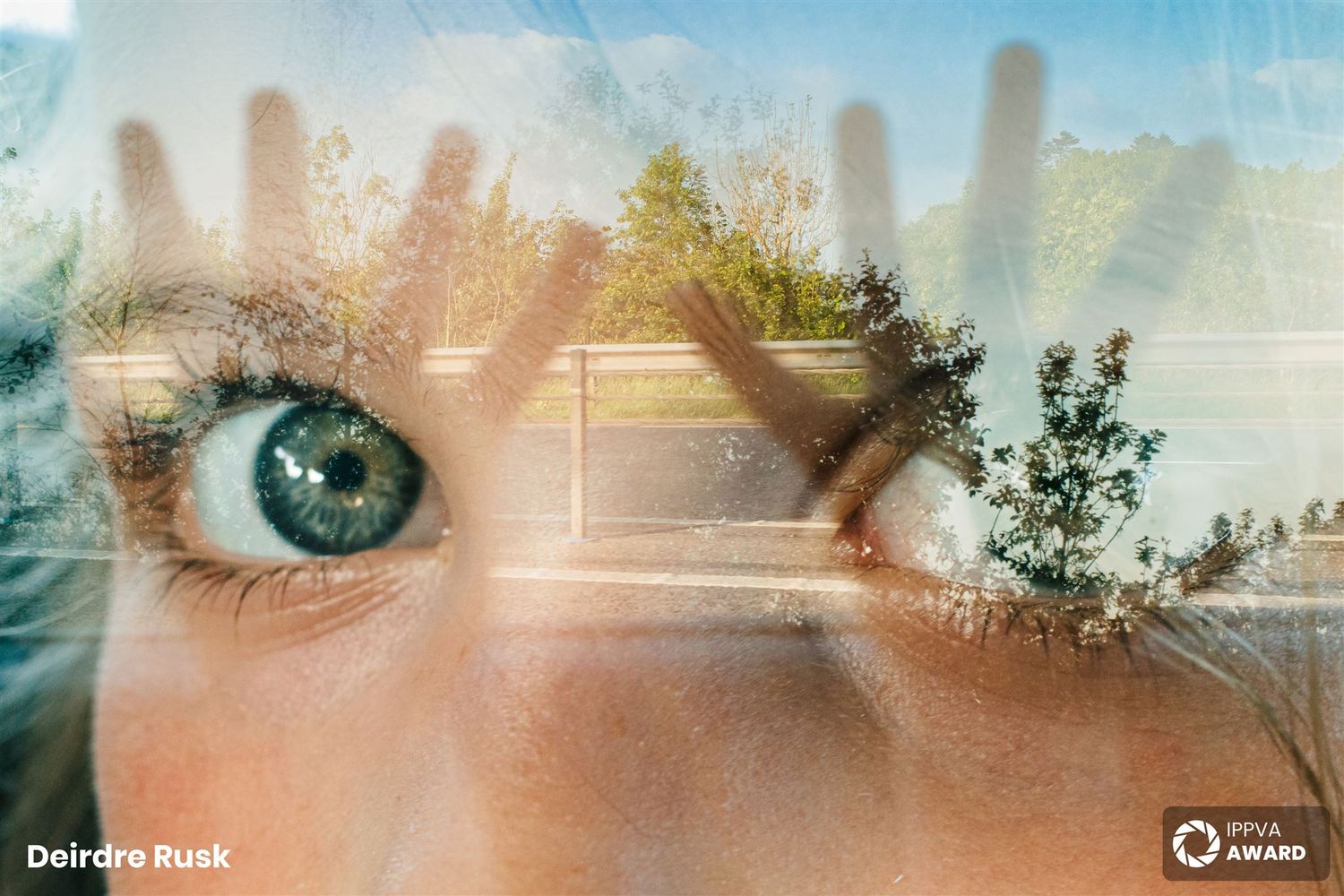 Artistic double exposure of eye and landscape through window. PHOTOGRAPHER Dublin