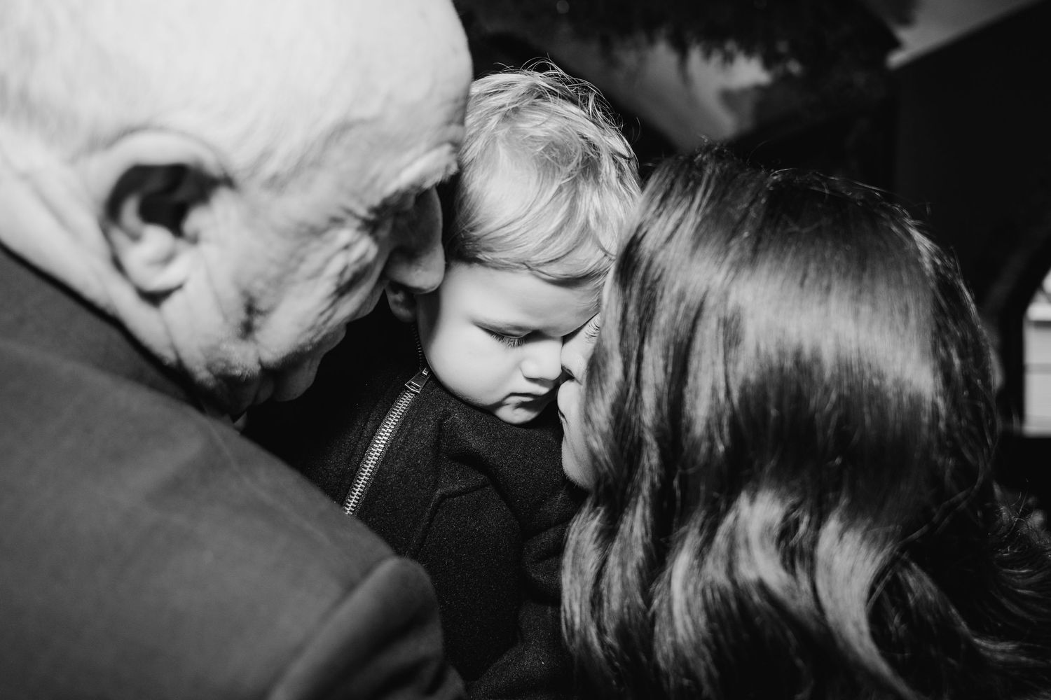 Intimate black and white candid moments captured between wedding guests.