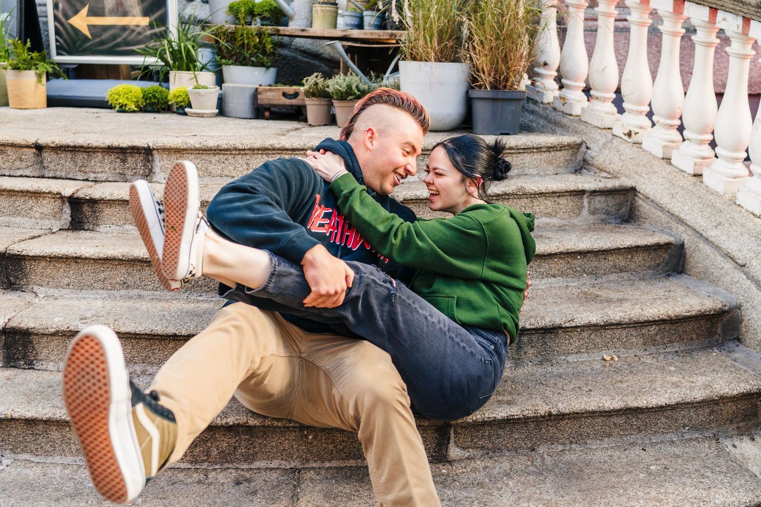 Two people playfully pose on stone steps outdoors. PHOTOGRAPHER Dublin Ireland
