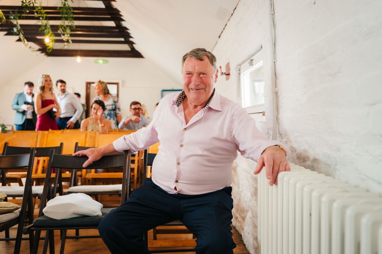 Wedding guest relaxing in a chair during the reception. Same sex wedding PHOTOGRAPHER Dublin