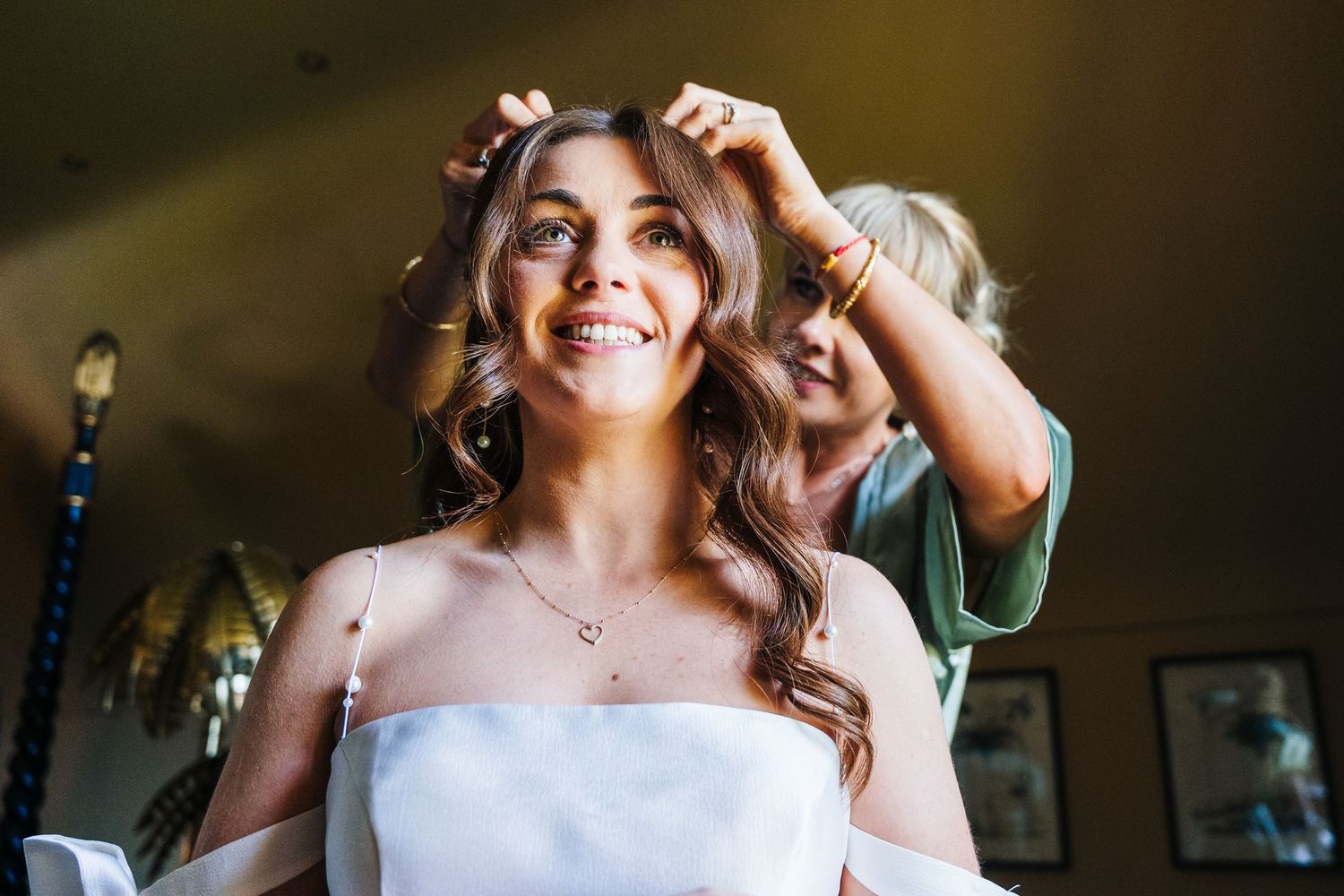 Castle Leslie Wedding Photographer Dublin Close-up shot of someone in a white dress with elegant curled hair and jewelry.