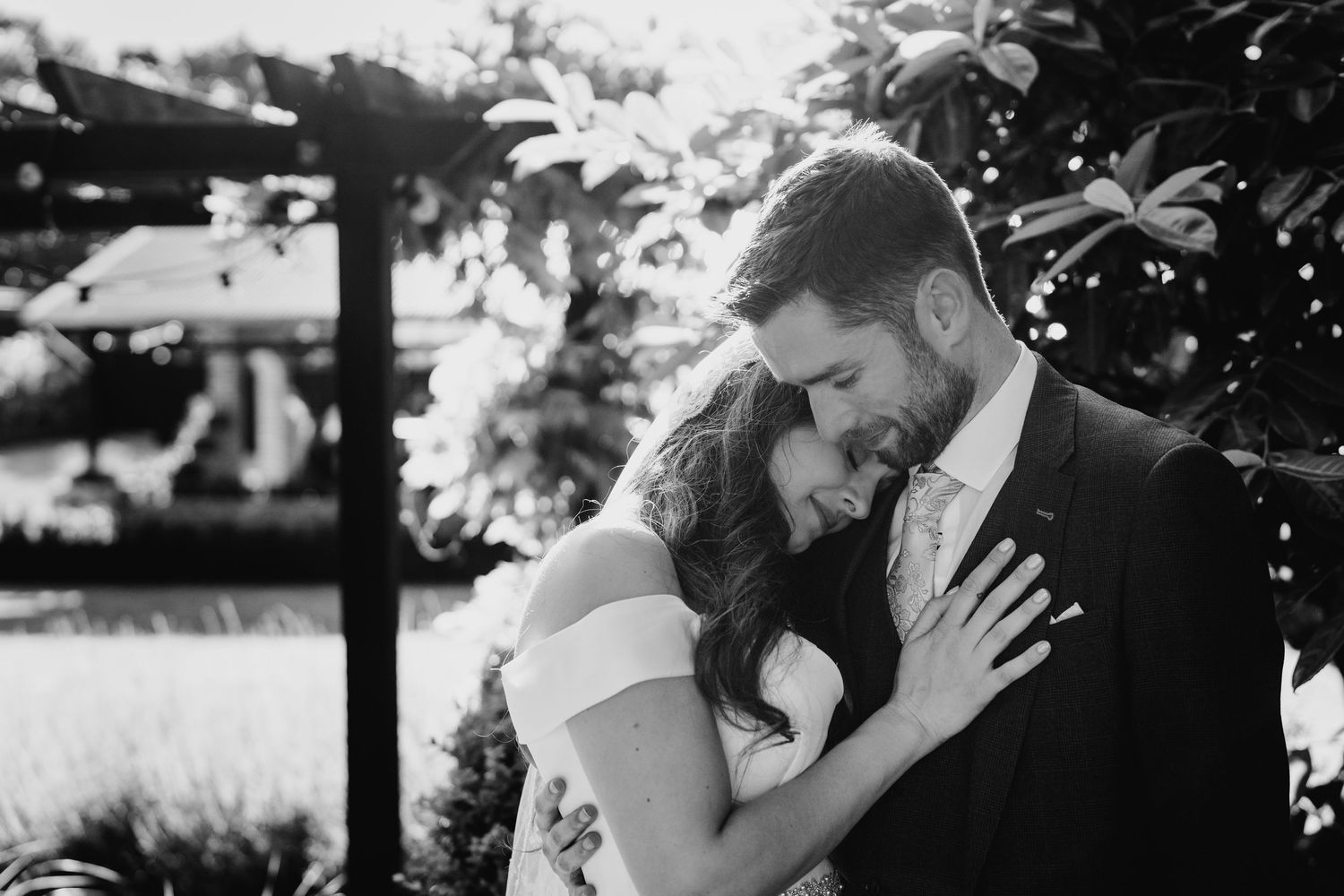 Poulaphouca Wedding photographer wicklow  An intimate black and white portrait of a couple sharing a tender moment outdoors.