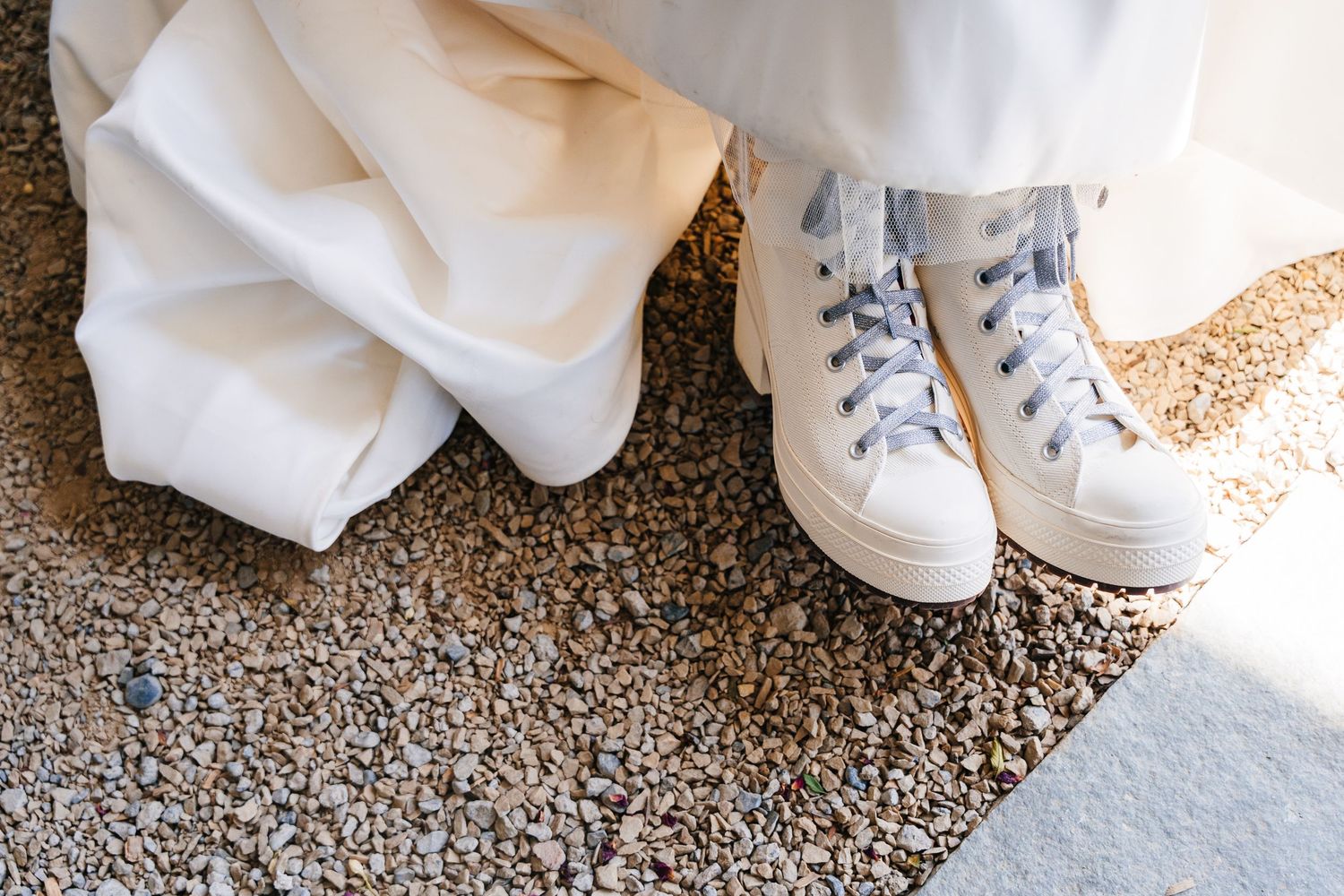 Poulaphouca Wedding photographer wicklow  White wedding dress fabric and matching white canvas sneakers shown on gravel ground.