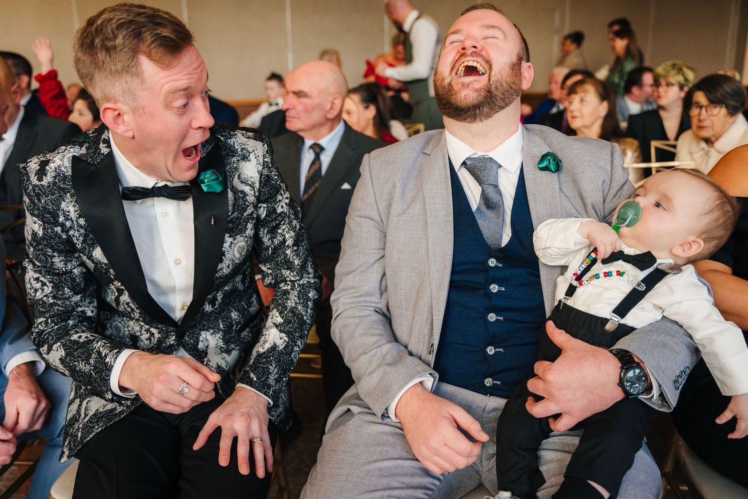 Candid reactions and laughter during formal event with guests in suits and formal attire.  Wedding PHOTOGRAPHER Trim Castle