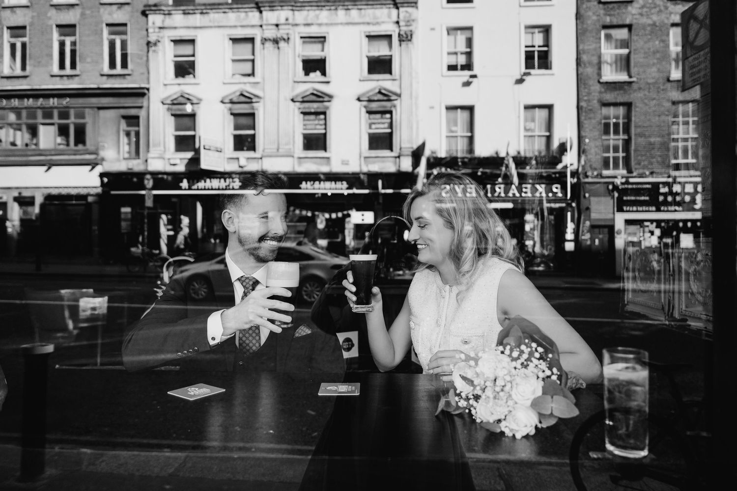 Black and white urban street scene with historic buildings and storefronts. City Hall Dublin wedding photogrAPher