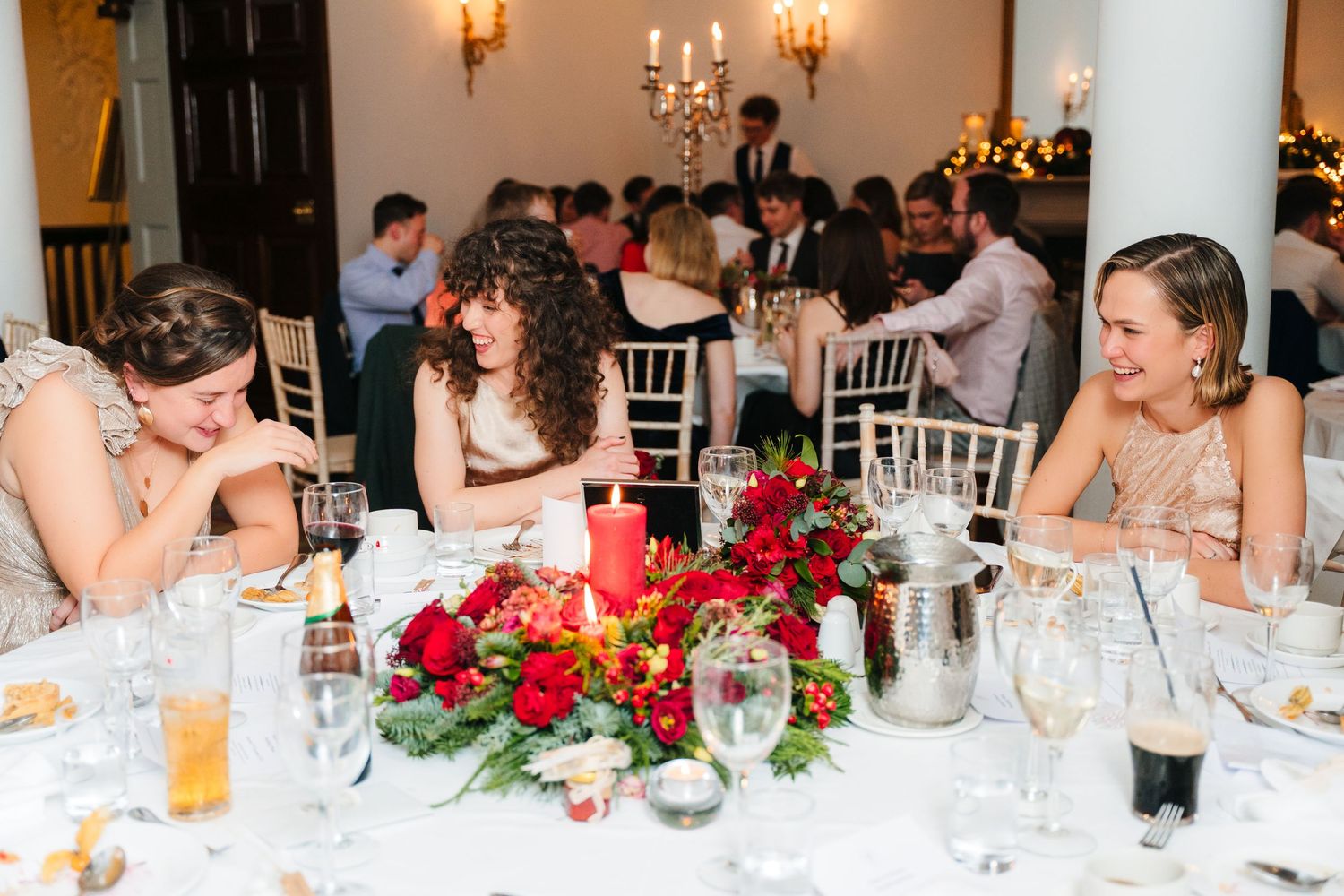 Wedding reception table with elegant red floral centerpiece and candlelight. Stephens green club dublin Wedding photographer
