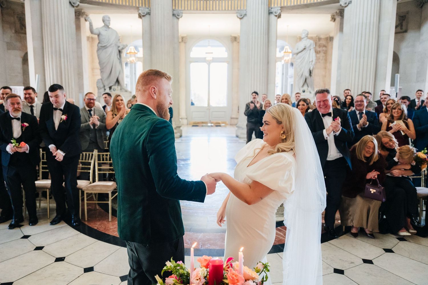 Couple exchanging vows in elegant rotunda surrounded by classical architecture.Wedding photographer dublin