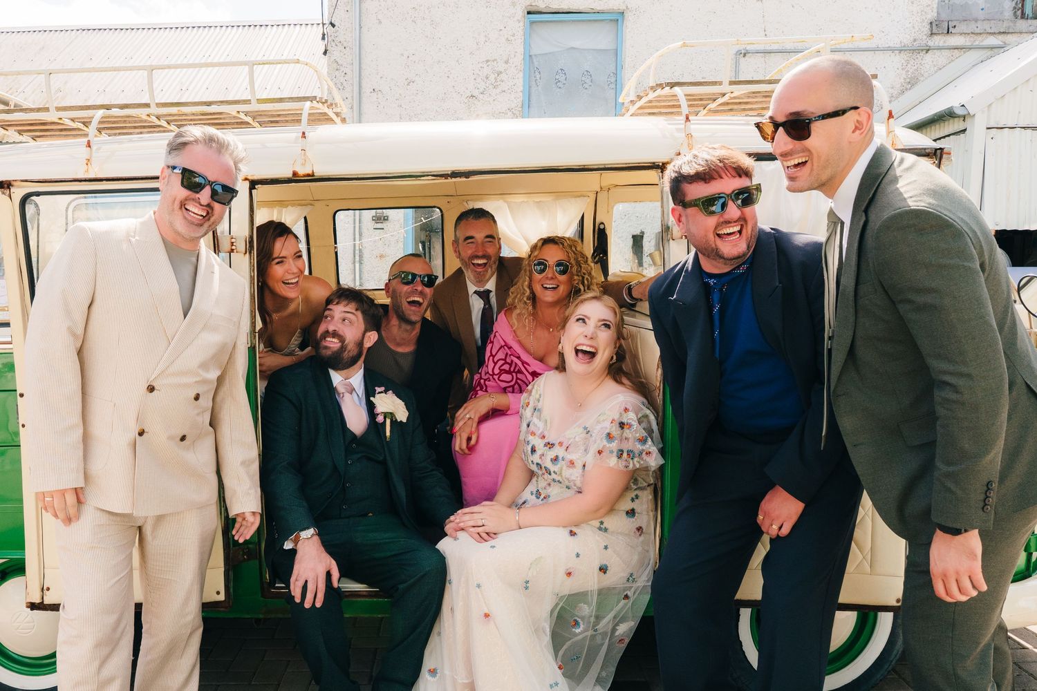 A group of well-dressed people pose together with a golf cart at an outdoor event. Wedding Photographer the BARN Dublin Tyrellspass