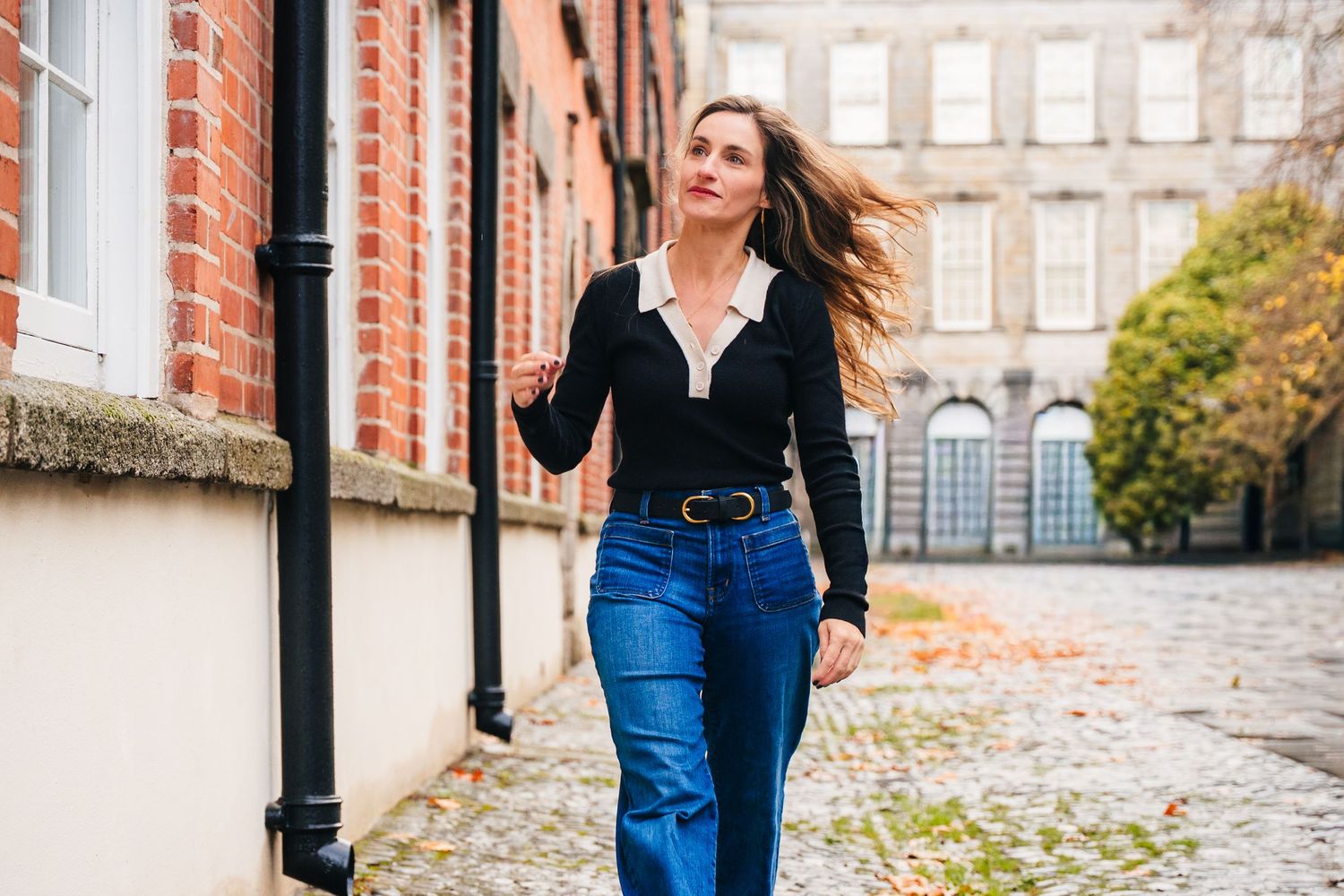 Street style photography against brick buildings and lamp posts in urban setting. professional headshots dublin photographer