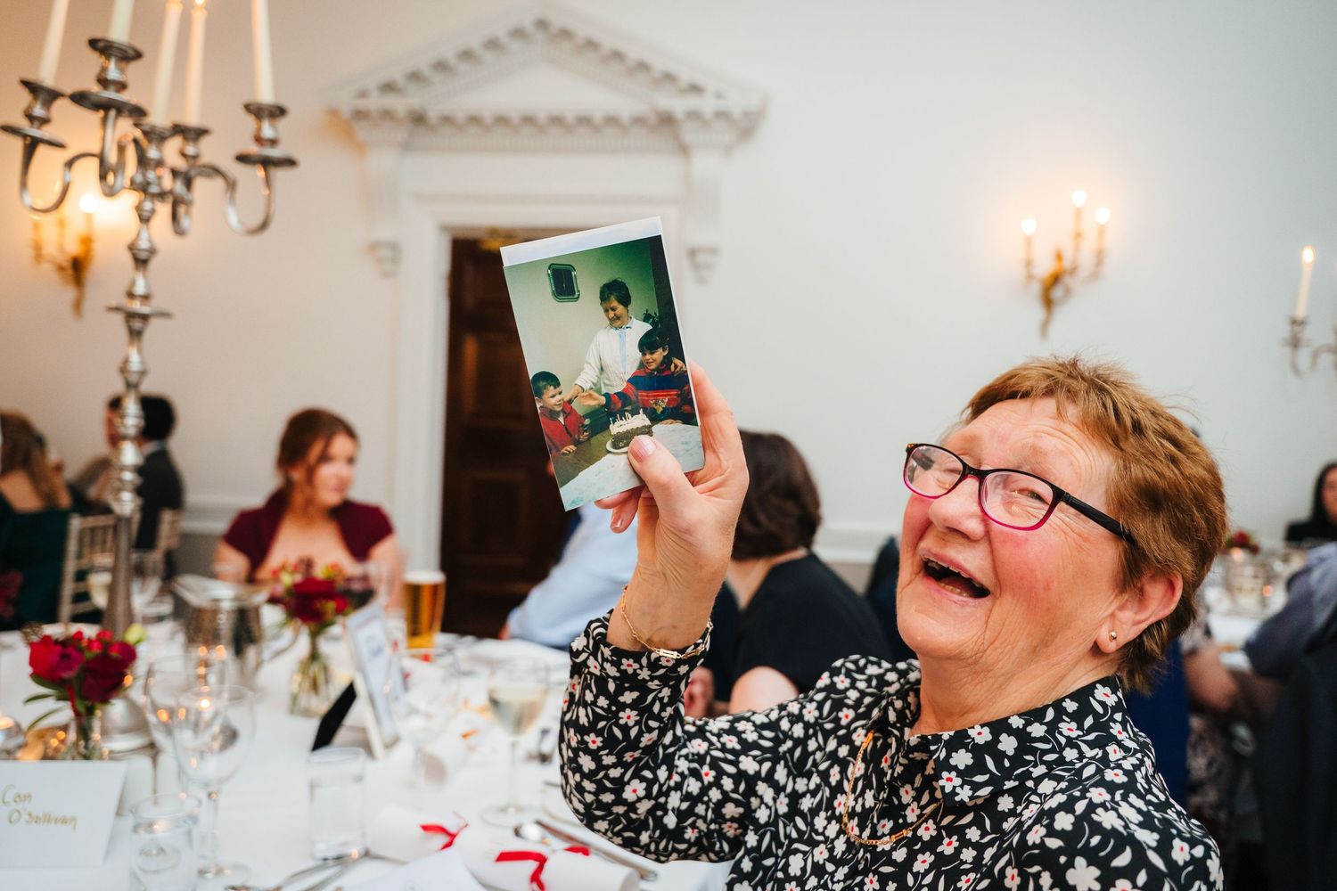 Wedding reception in an elegant room with chandelier and candlelit tables. Stephens green club dublin Wedding photographer