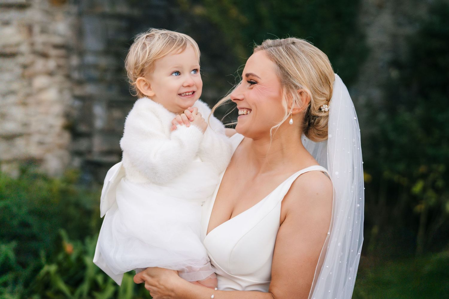 A tender moment shared between two people in white attire during a wedding celebration. Ballymagarvey Wedding photographer