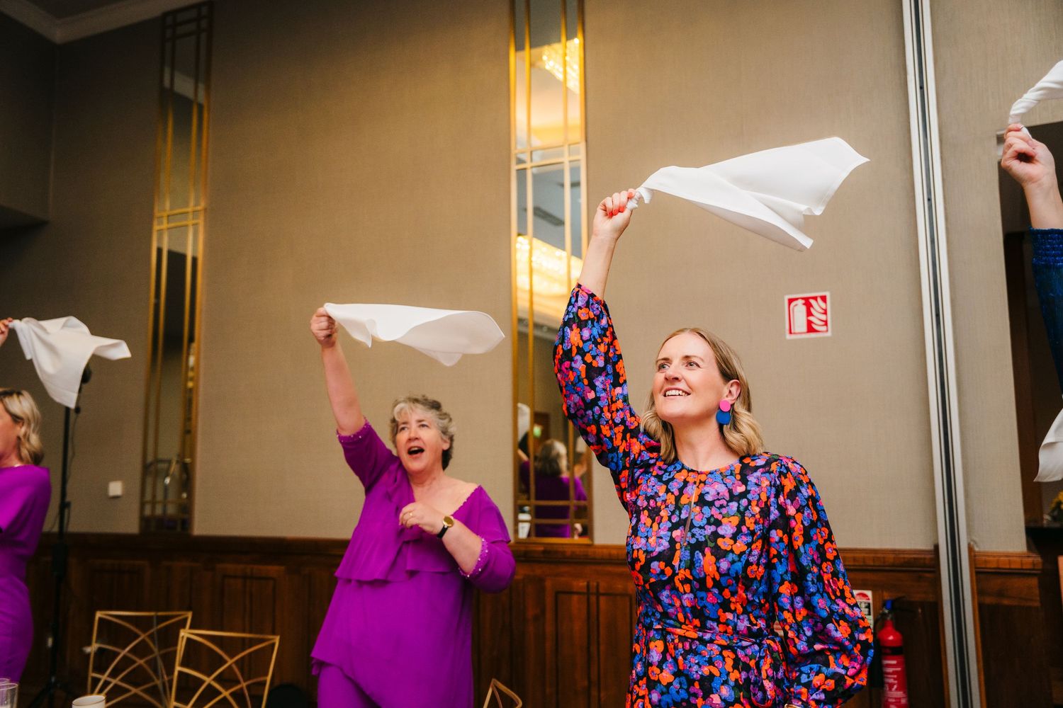 Wedding guests having fun waving white napkins during reception celebration.Wedding Photography Trim Castle Ireland