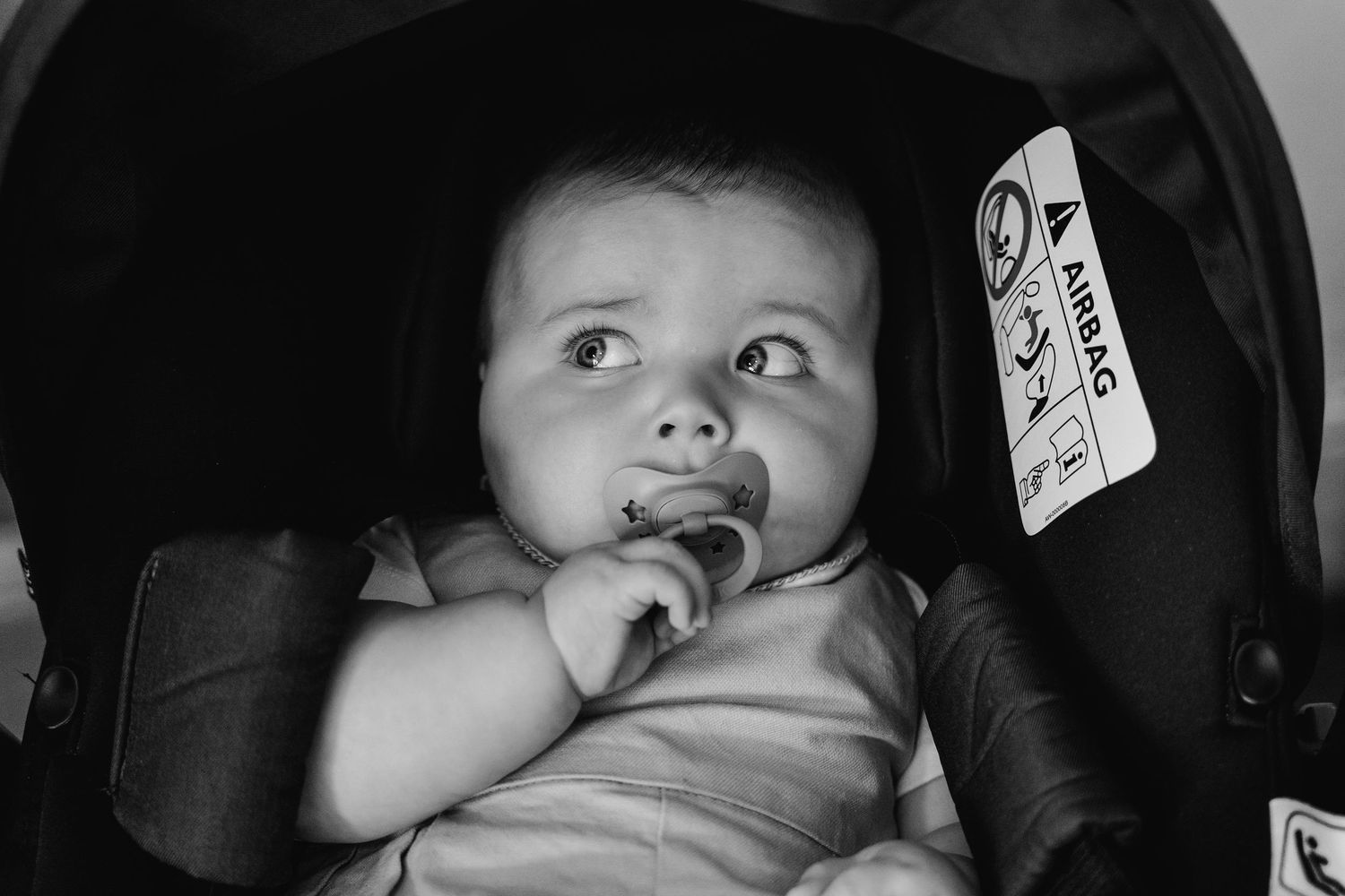 Millhouse slane wedding photographer dublin Black and white photos of an infant in a car seat making various expressions.