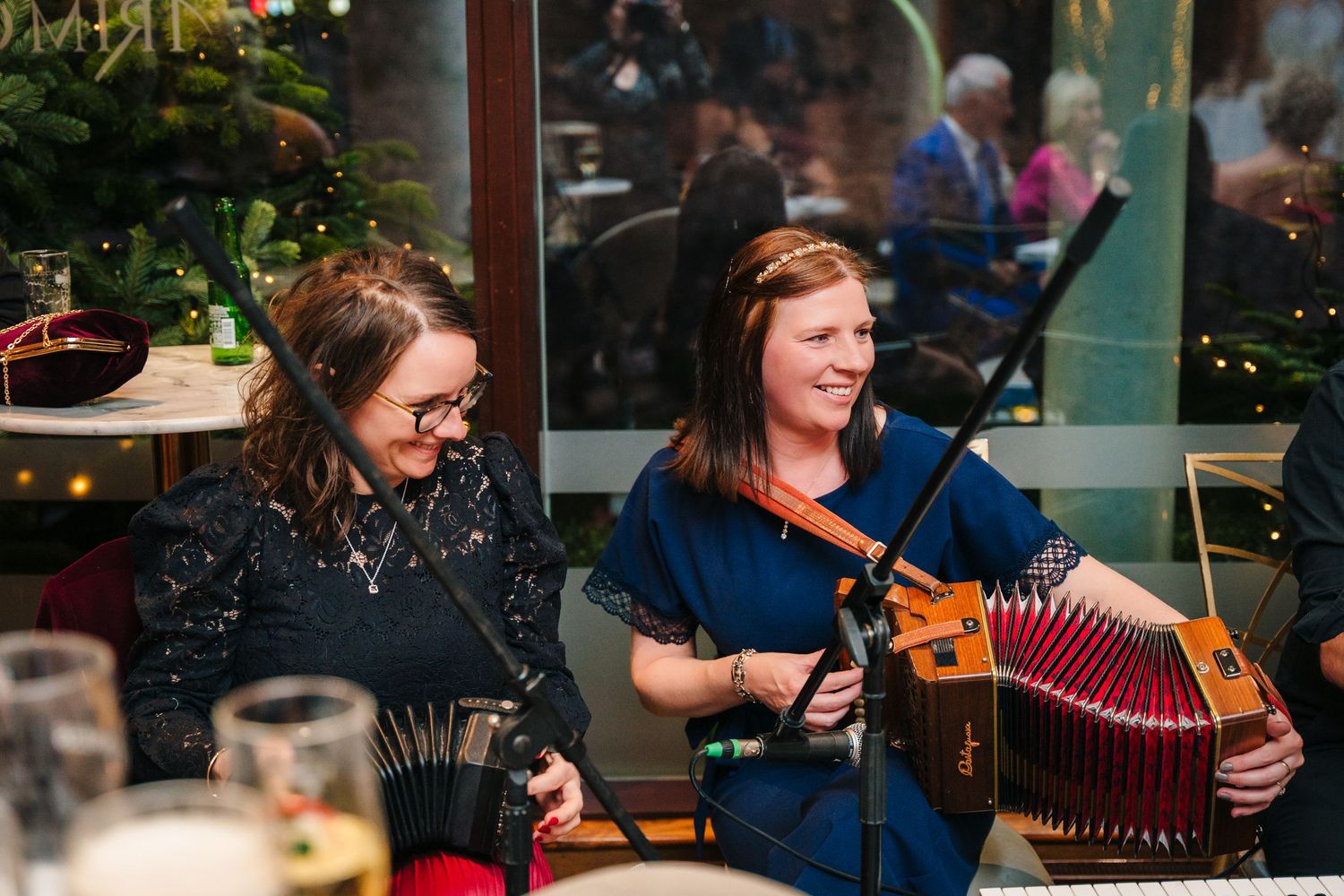 Musicians perform traditional folk music with accordions during an evening celebration.  Wedding PHOTOGRAPHER Trim Castle