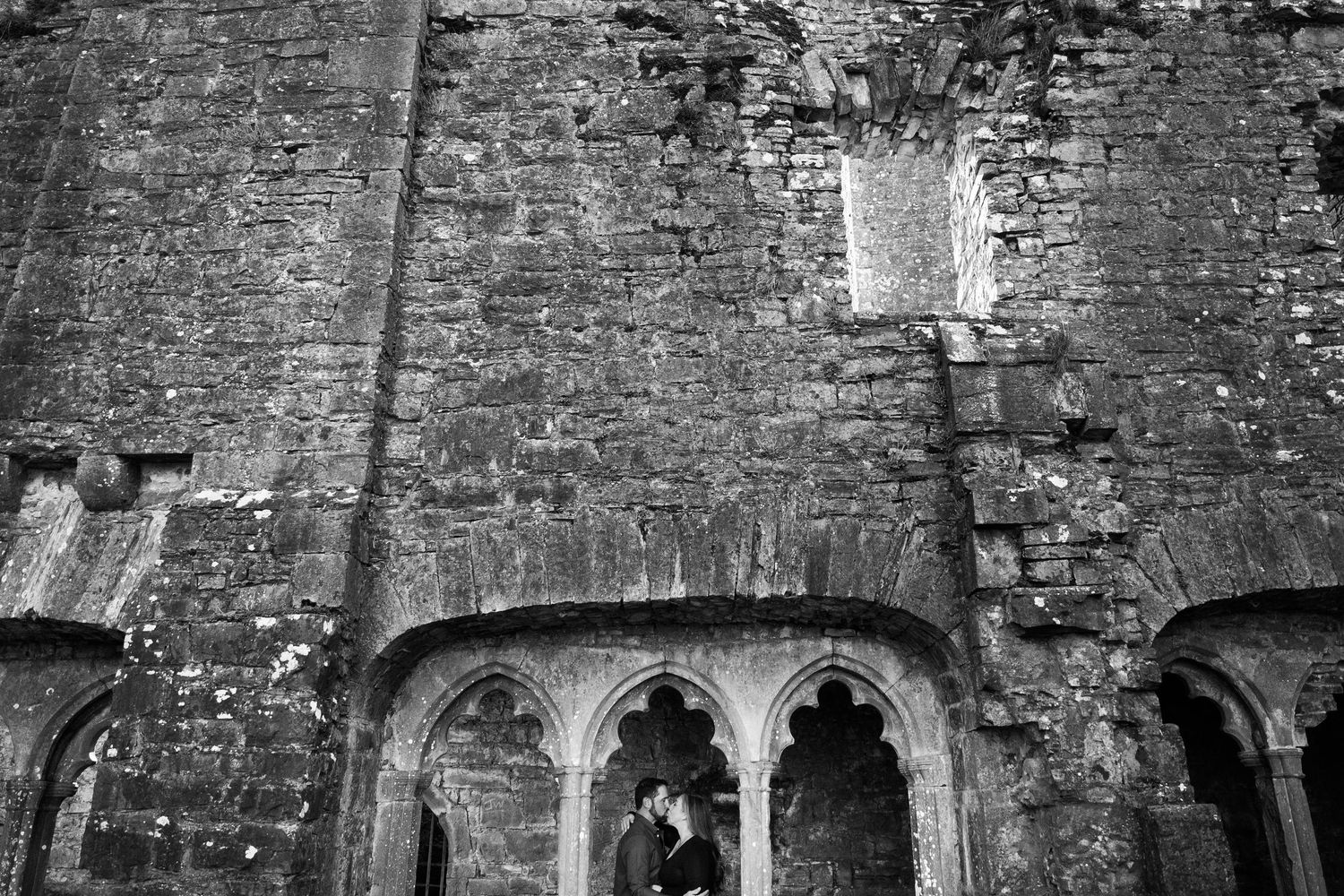 A series showing an old stone castle wall with arched windows in black and white. Family PHOTOGRAPHER Dublin