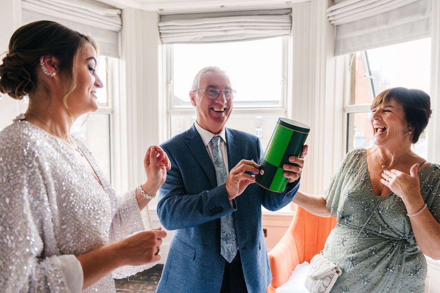 Series of casual interaction photos capturing joyful conversations near bright bay windows. House Dublin Wedding Photographer