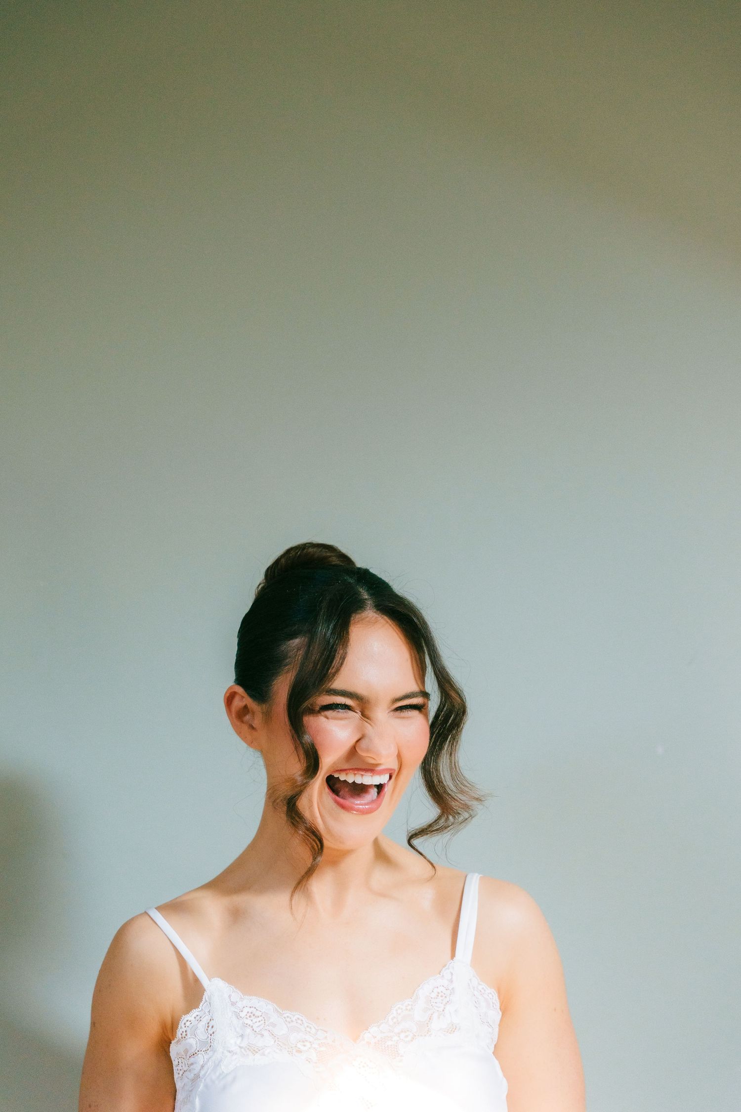 A series of candid bridal portraits showing joyful laughter and natural expressions against a light background. Virginia Park Lodge Wedding