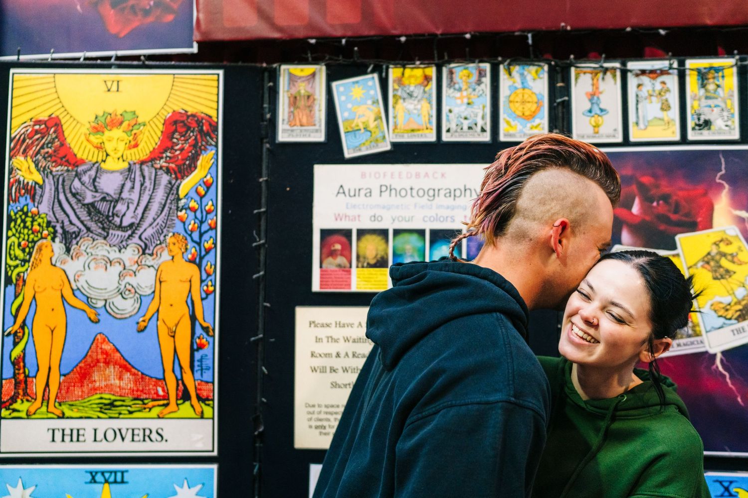 Art prints and tarot cards displayed on a colorful wall in an eclectic retail shop with vibrant lighting. PHOTOGRAPHER Dublin ireland