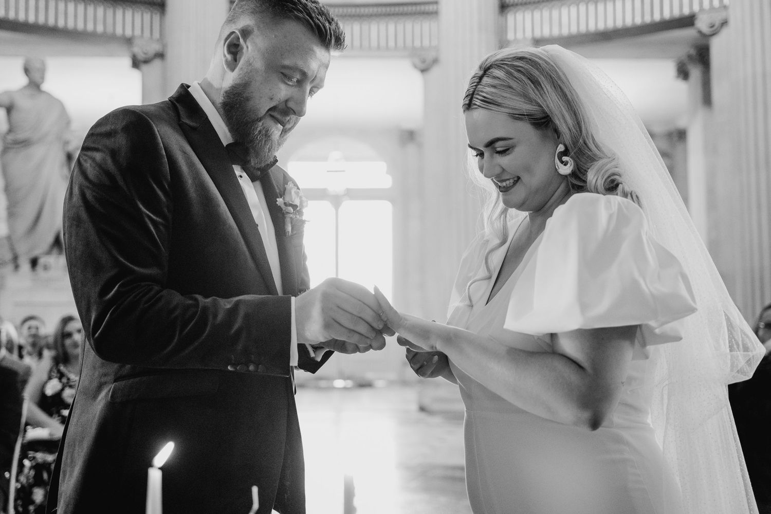 Black and white candid moments from a wedding ceremony in a pillared venue.  Wedding photographer dublin