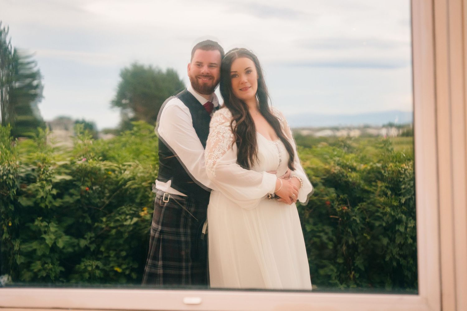 Wedding couple posing for romantic photos against a scenic outdoor backdrop. Portmarnock Hotel Wedding PHOTOGRAPHER Dublin