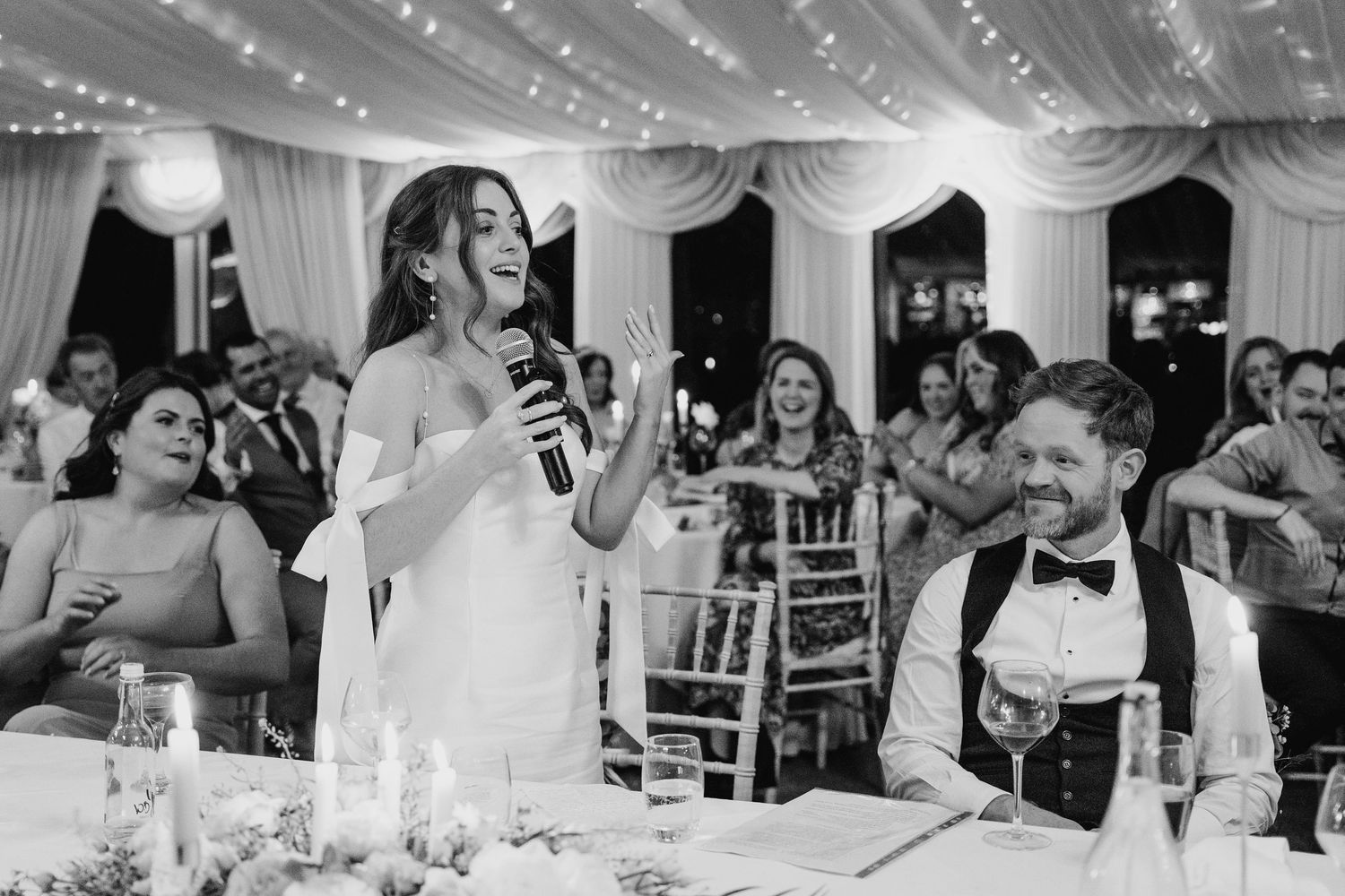 Castle Leslie Wedding Photographer Dublin A wedding reception speech moment under elegant draped fabric ceiling with twinkling lights.
