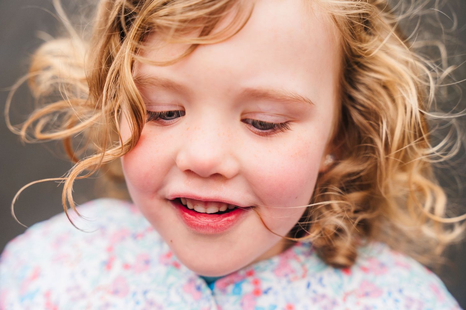 Family photographer Dublin Ireland  Close-up portrait showing curly blonde hair and gentle expression.