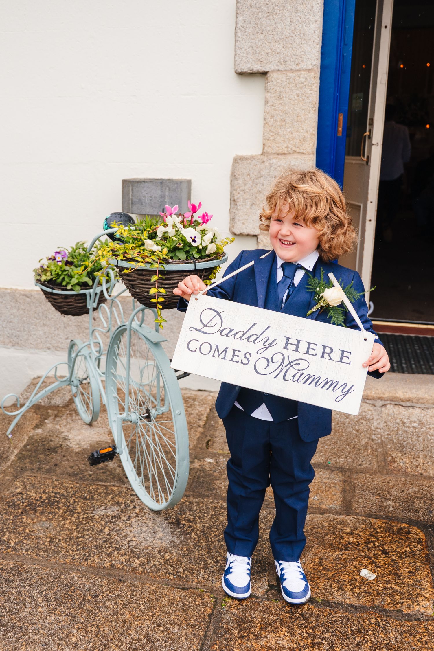 Decorative blue bicycle with flower baskets and wedding signs reading 'Daddy HERE' and 'Mommy'. The Dean Dublin Wedding Photographer