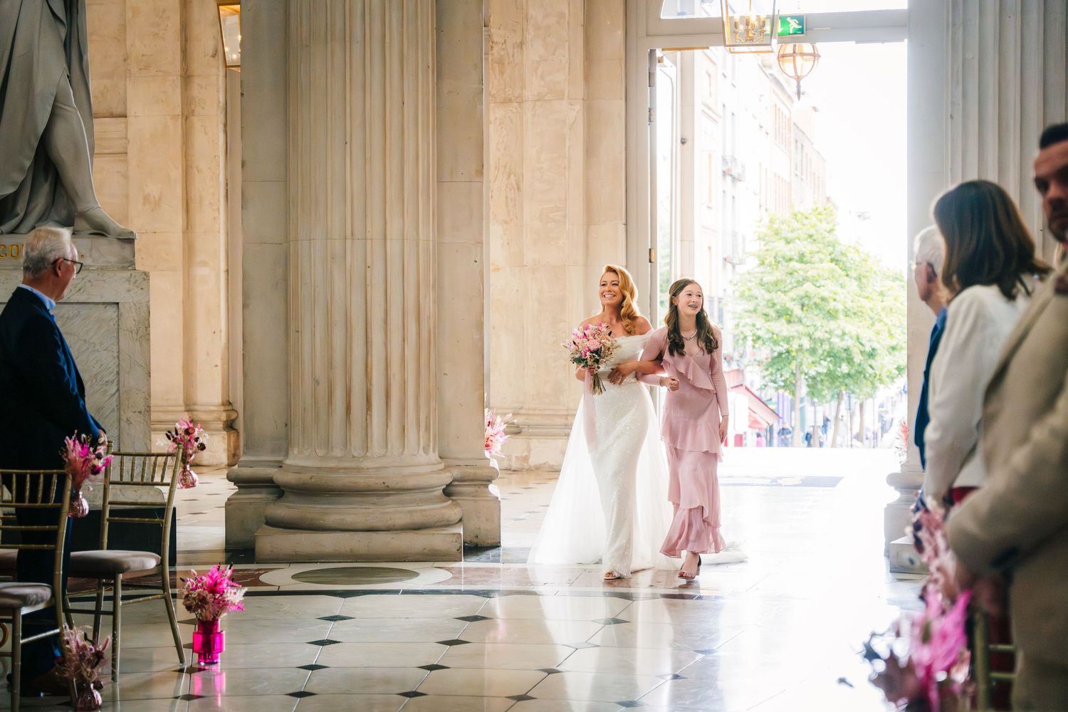 Elegant columned hallway with natural light streaming through large windows.  city hall dublin wedding photos