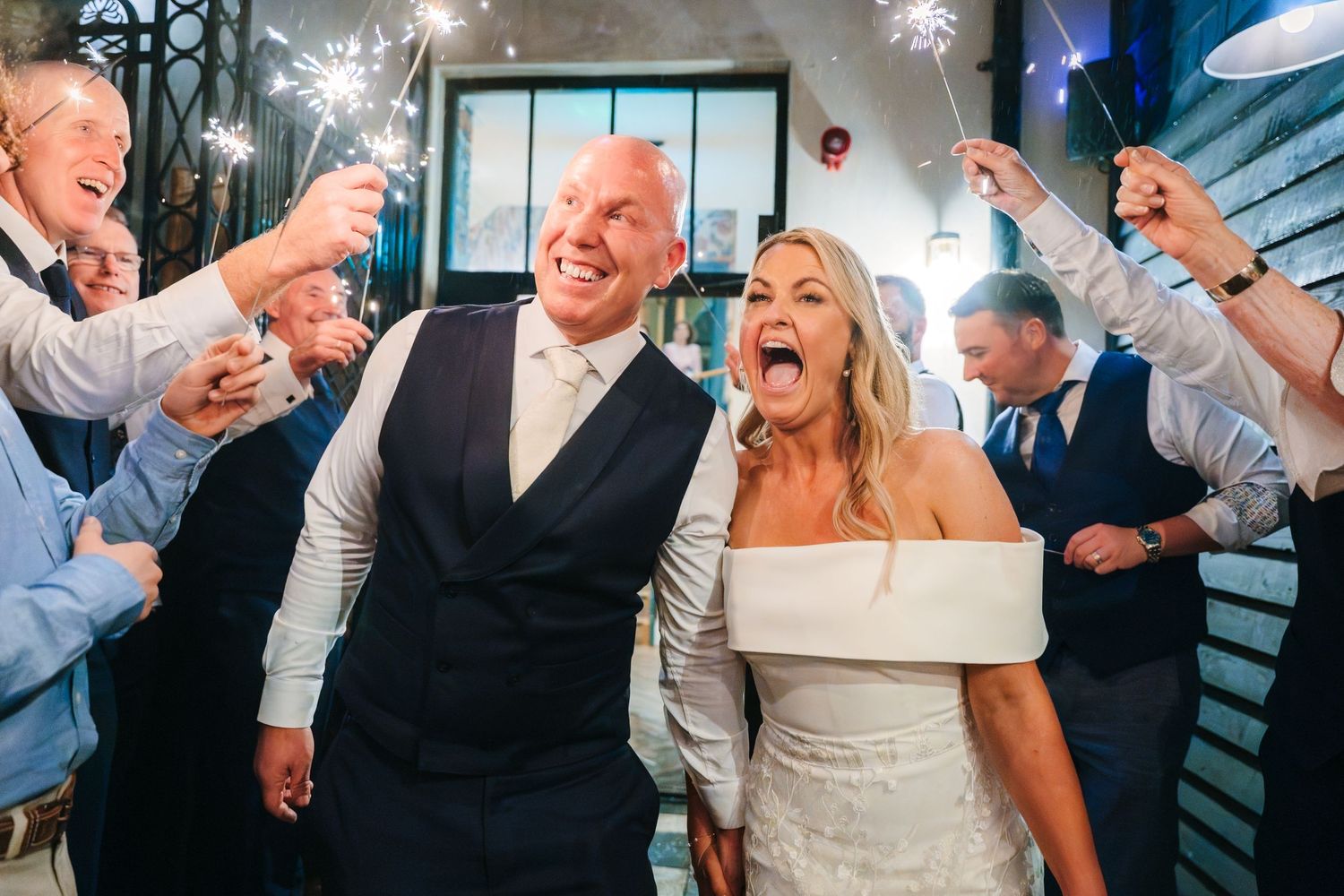 Lively wedding reception celebration with guests dancing and celebrating in an indoor venue. The Dean Dublin Wedding Photographer