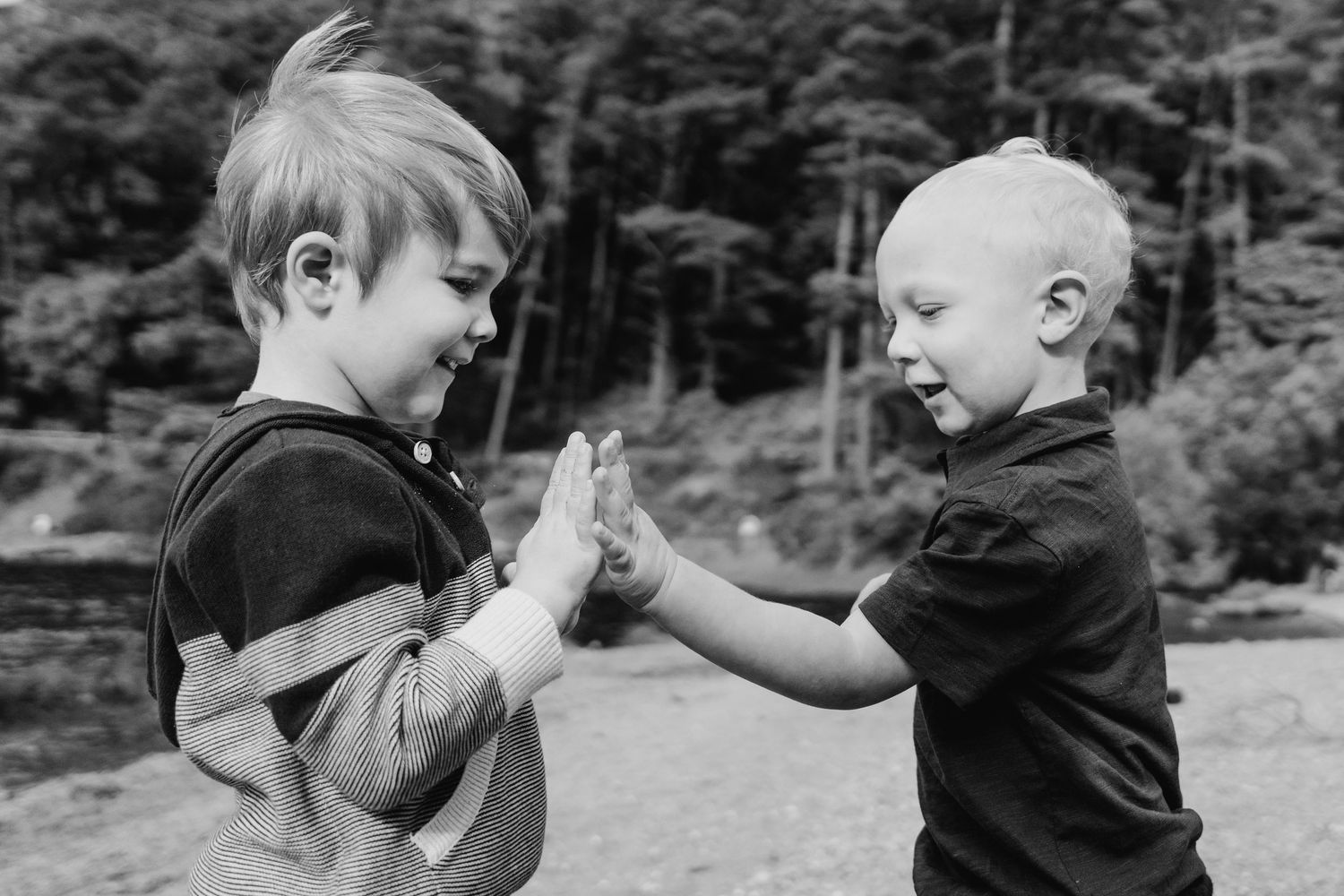 A sequence of black and white photos showing two children playing and interacting outdoors. Family photogrAPHER DUBLIN