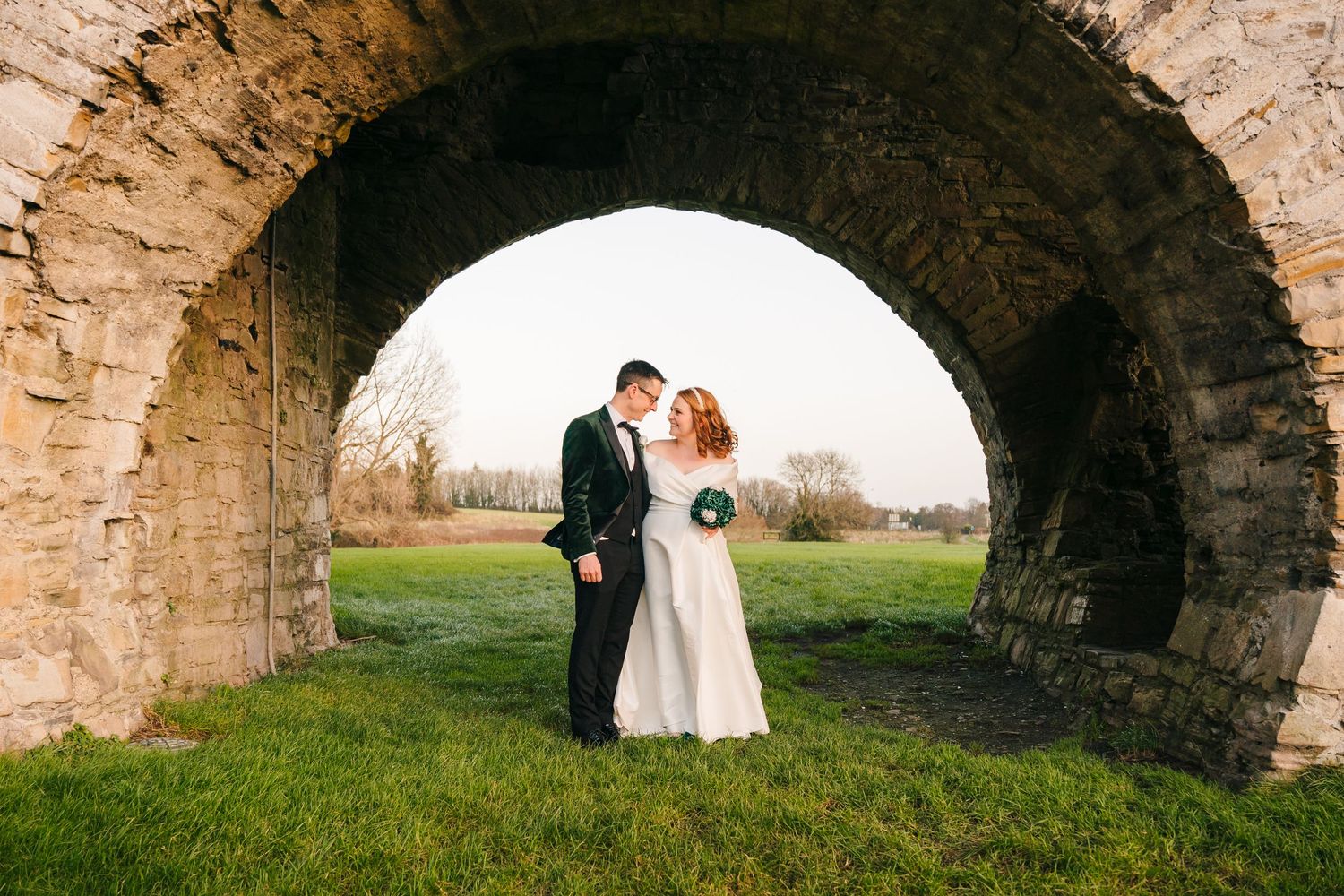 Stone archways create beautiful framing for wedding portraits in a historic setting.  Wedding PHOTOGRAPHER Trim Castle