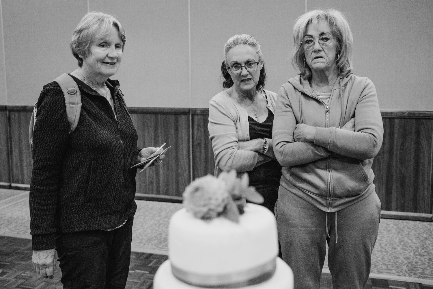 Montage of eight black and white photos showing people preparing, decorating and blowing out candles on birthday cakes. Wedding Photography