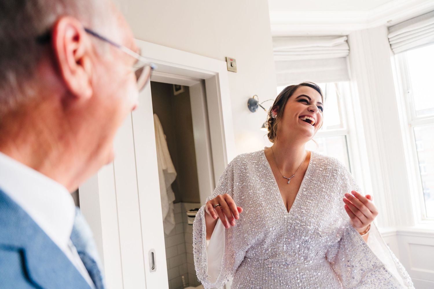 Two people share a joyous moment in a bright indoor setting. House Dublin Wedding Photographer