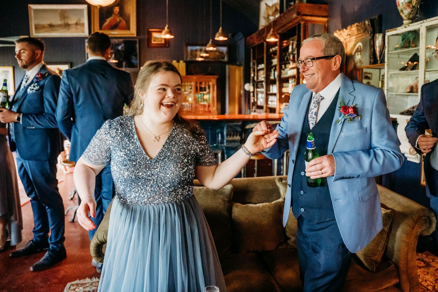Wedding guests enjoying drinks and conversation at a vintage-styled reception venue. Wedding photographer Dublin