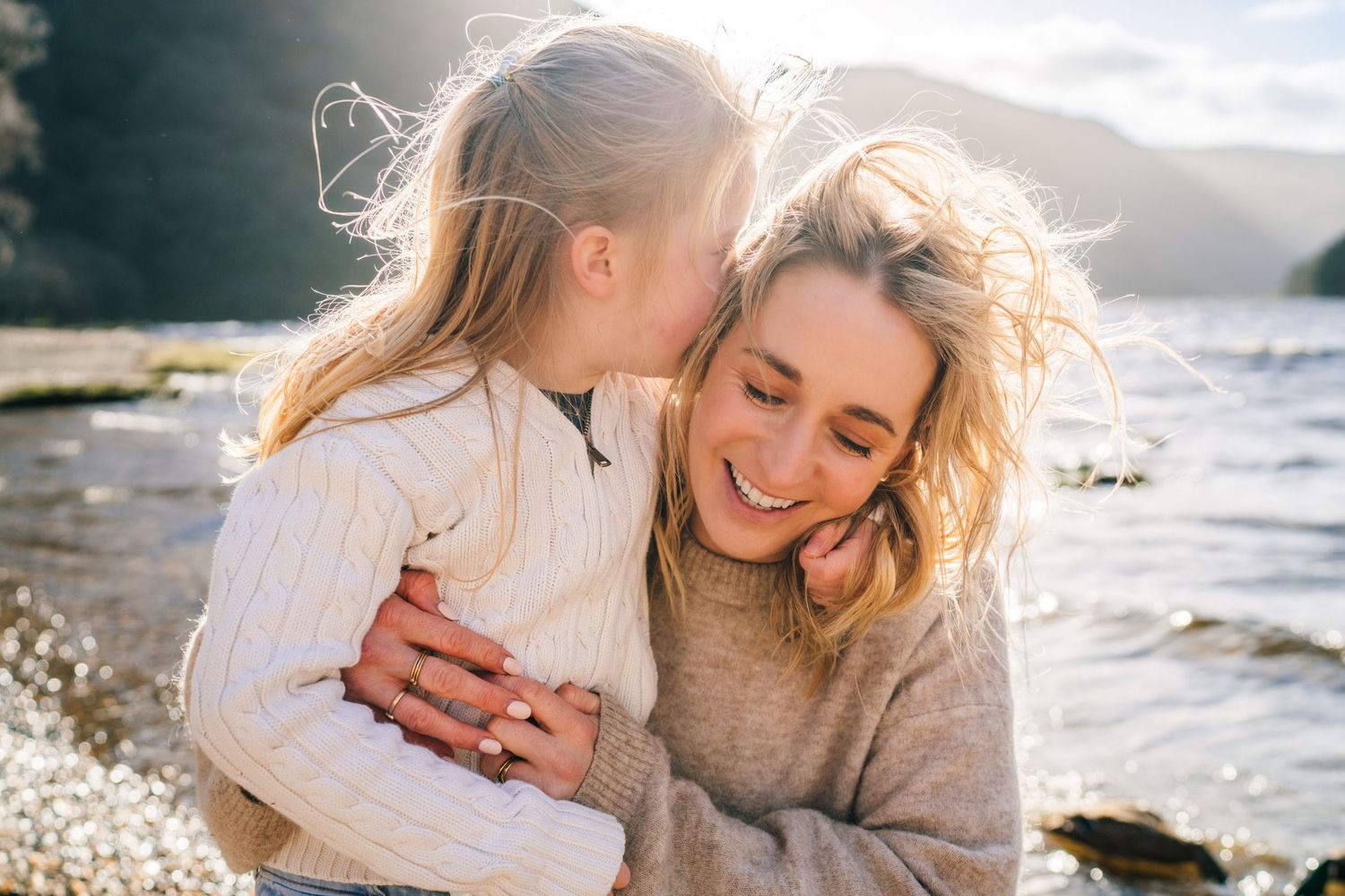 Romantic couple photoshoot at sunset on a beach with glowing golden light and crashing waves in background. family PHOTOGRAPHER Dublin