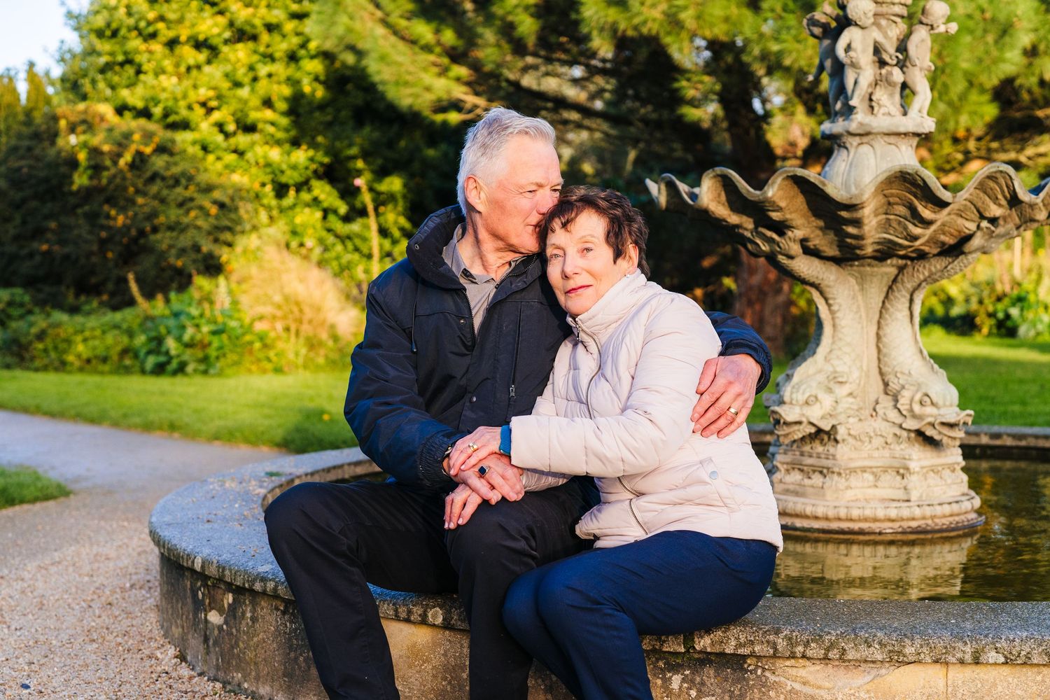 Tender moments between loved ones are captured in a garden setting with stone architecture and golden sunlight. PHOTOGRAPHER Dublin ireland