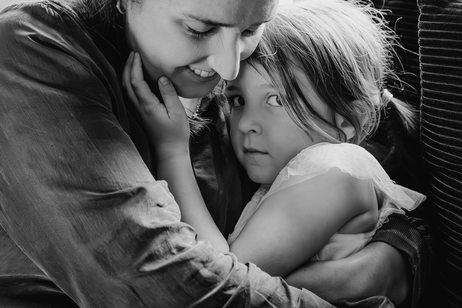 A tender black and white portrait of a parent and child sharing an intimate moment of connection and love. family PHOTOGRAPHER Dublin