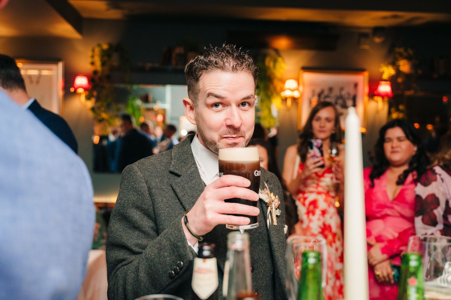 Warm-toned reception photos capturing social moments at a bar with ambient lighting.