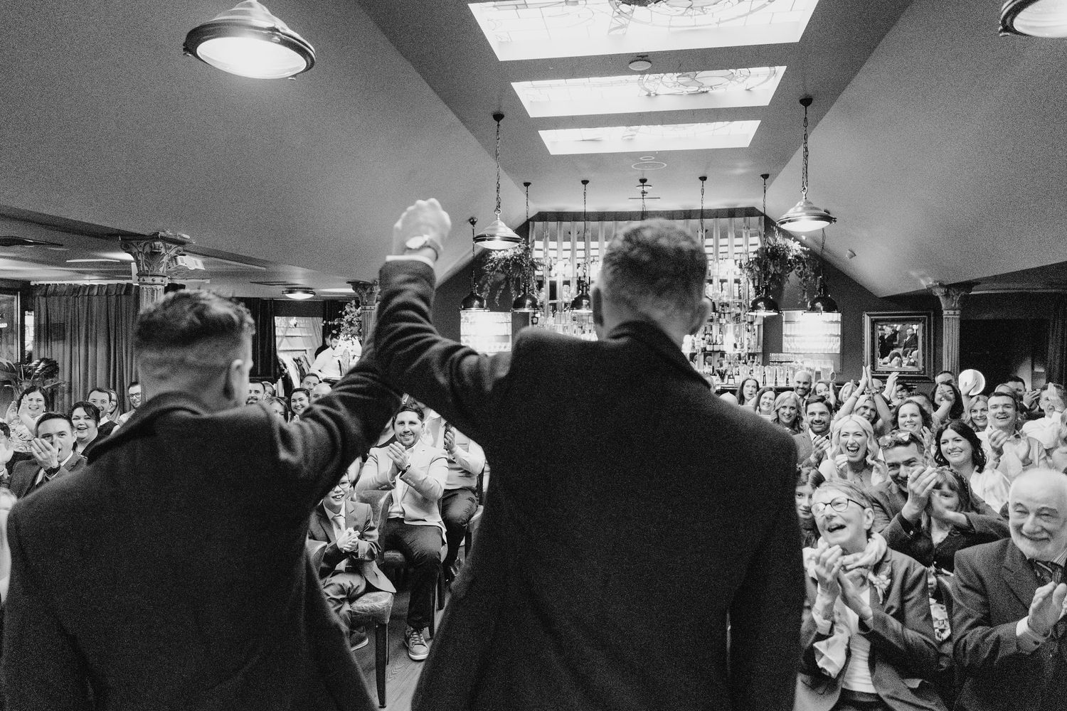 Black and white photos of wedding celebration moments in a venue with skylight. Marco Pierre Dublin Wedding Photographer
