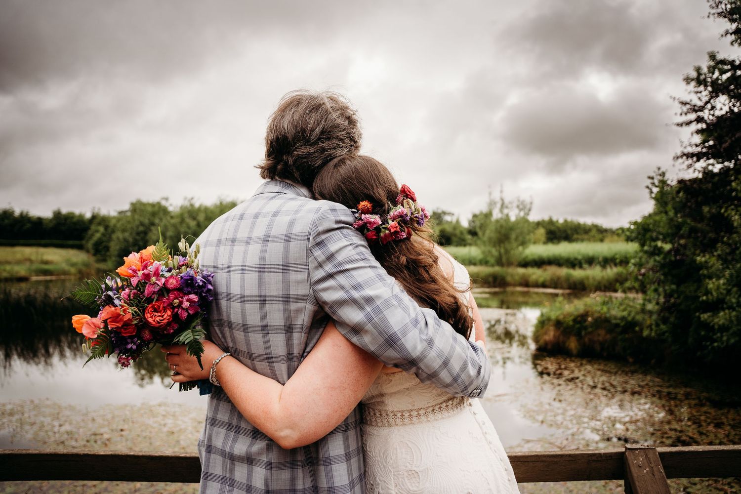 Romantic wedding photos taken against dramatic cloudy sky with natural landscape. Wedding photographer Dublin