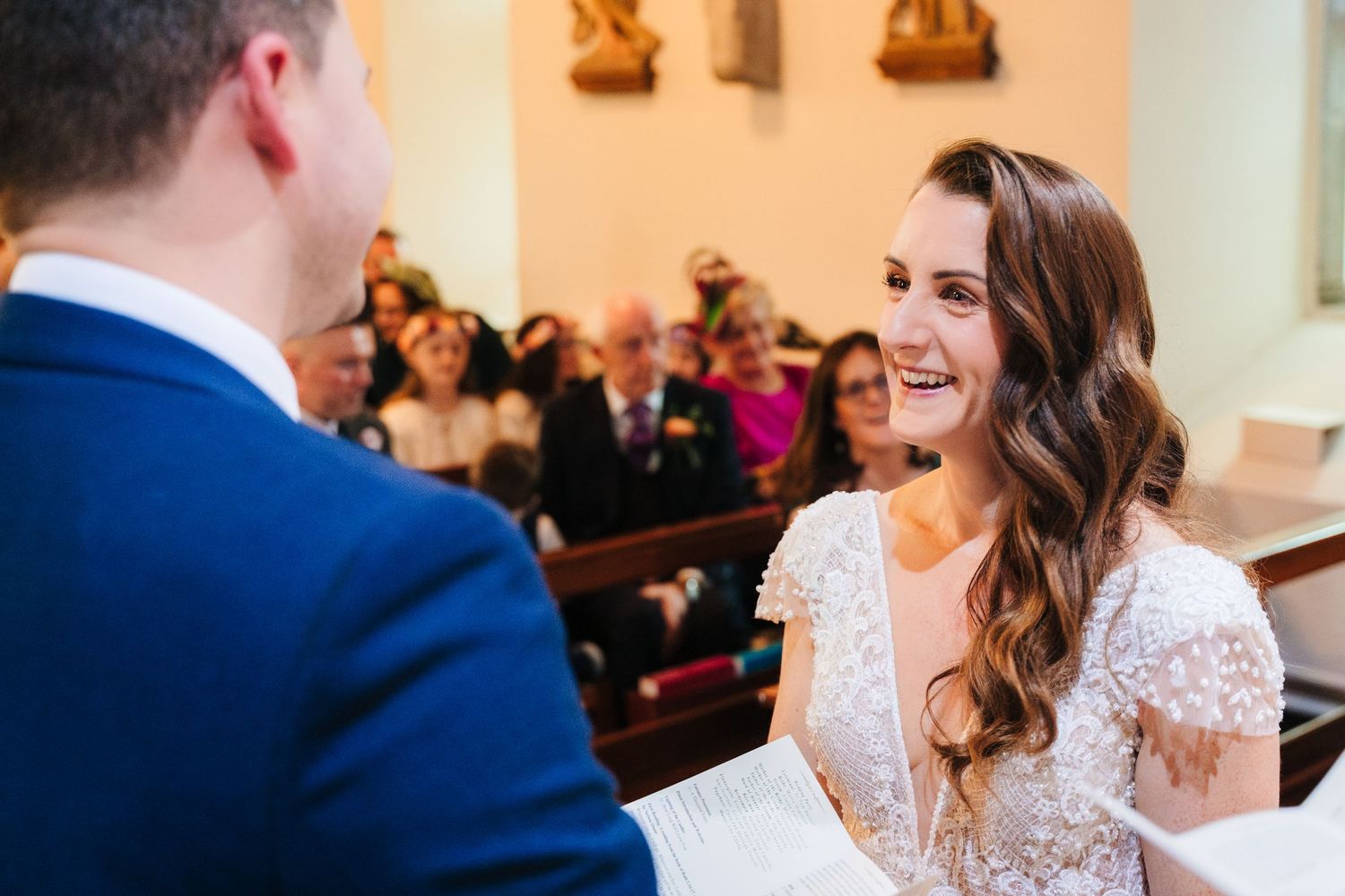 Bride and groom sharing intimate moments during church wedding ceremony.