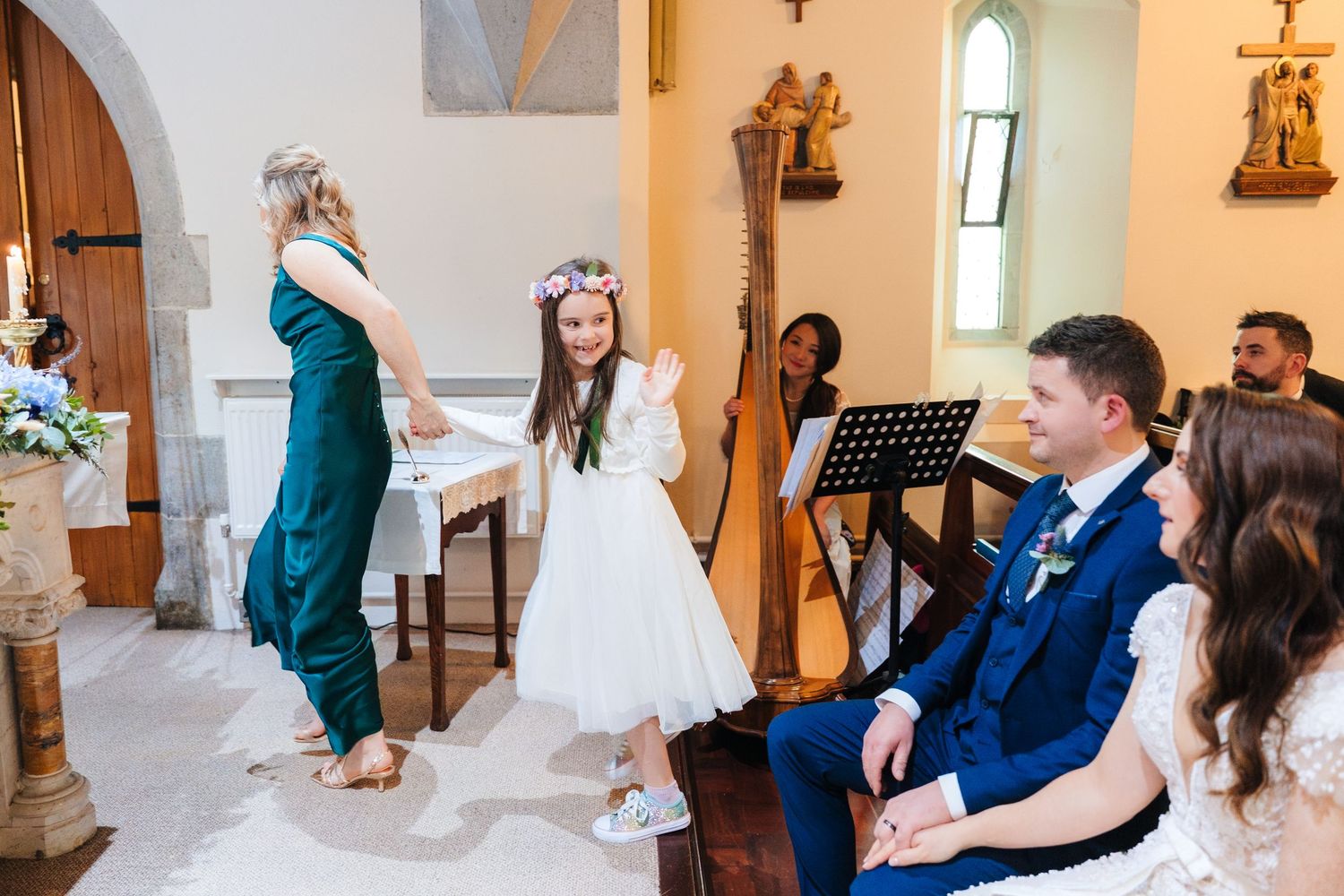 Guests seated in wooden church pews during a traditional wedding ceremony.