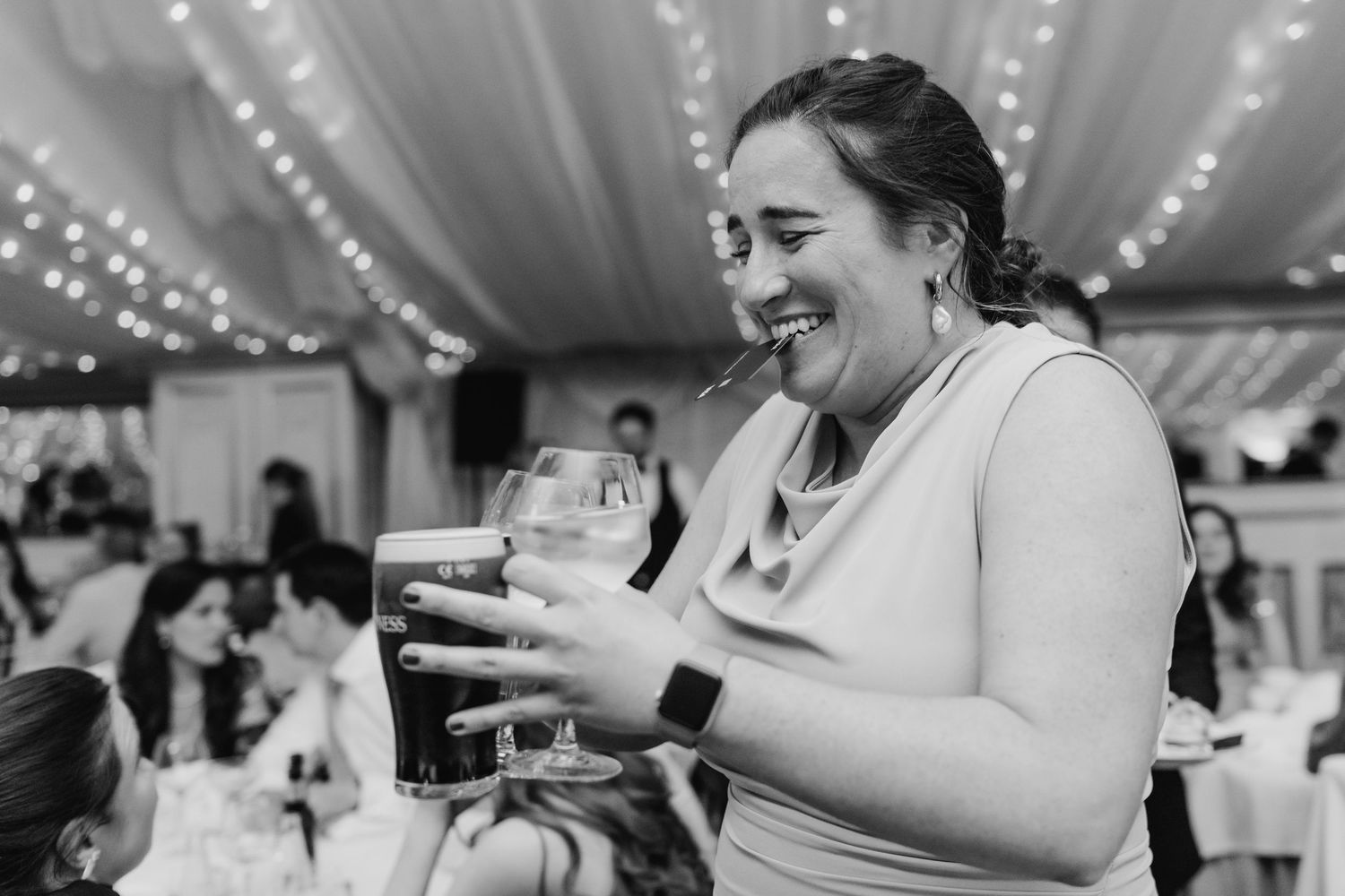 A series of candid moments from a wedding reception showing guests dancing and celebrating under twinkling lights. wedding photographer dubl