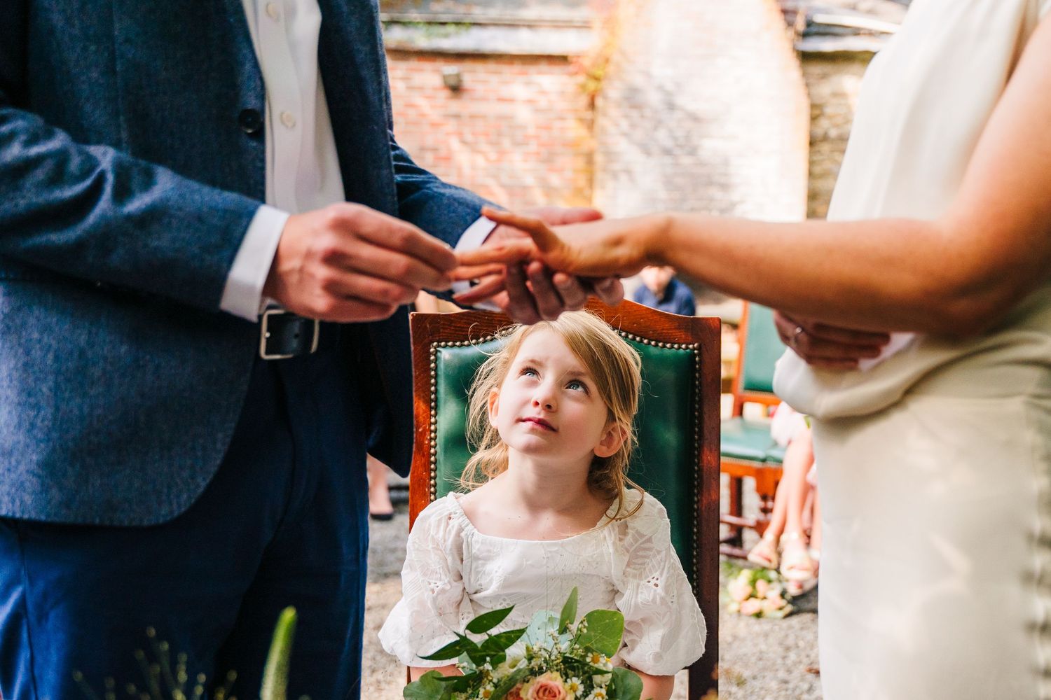 Bride and groom share an intimate moment during their outdoor wedding ceremony with guests looking on. wedding photographer dublin pricing m