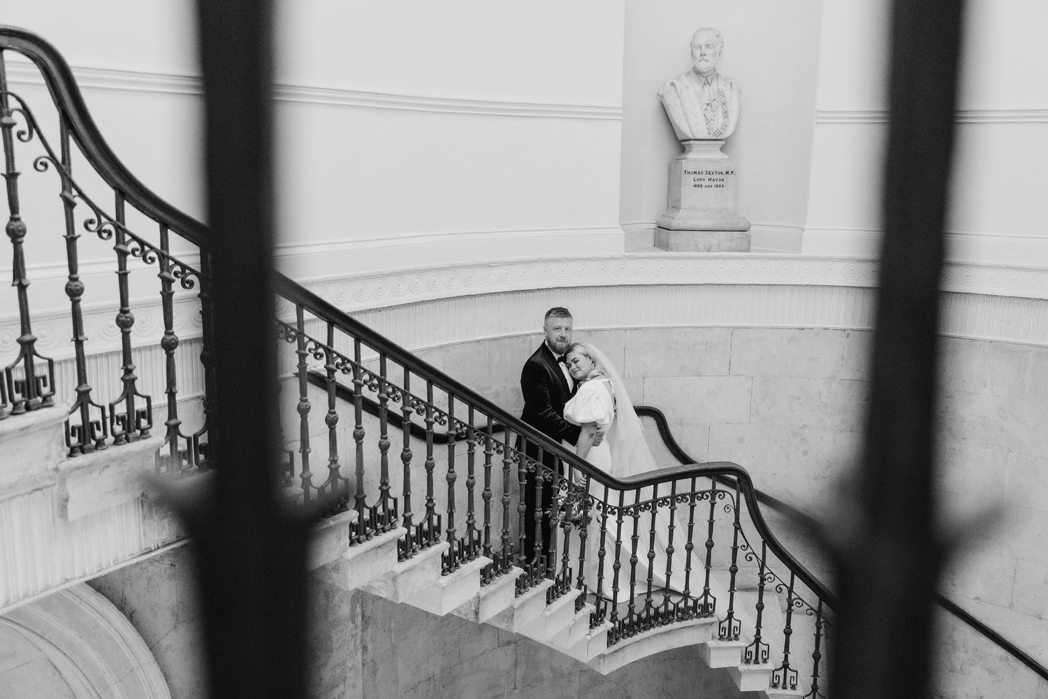 Architectural detail of a grand staircase with wrought iron railings in black and white. Wedding photographer dublin