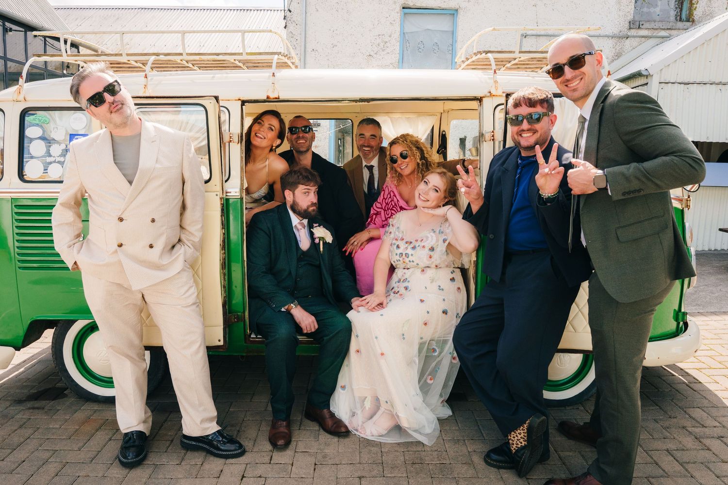 Wedding party poses together in front of a vintage green and white van. . Village Barn Tyrrellspass wedding photographer Ireland