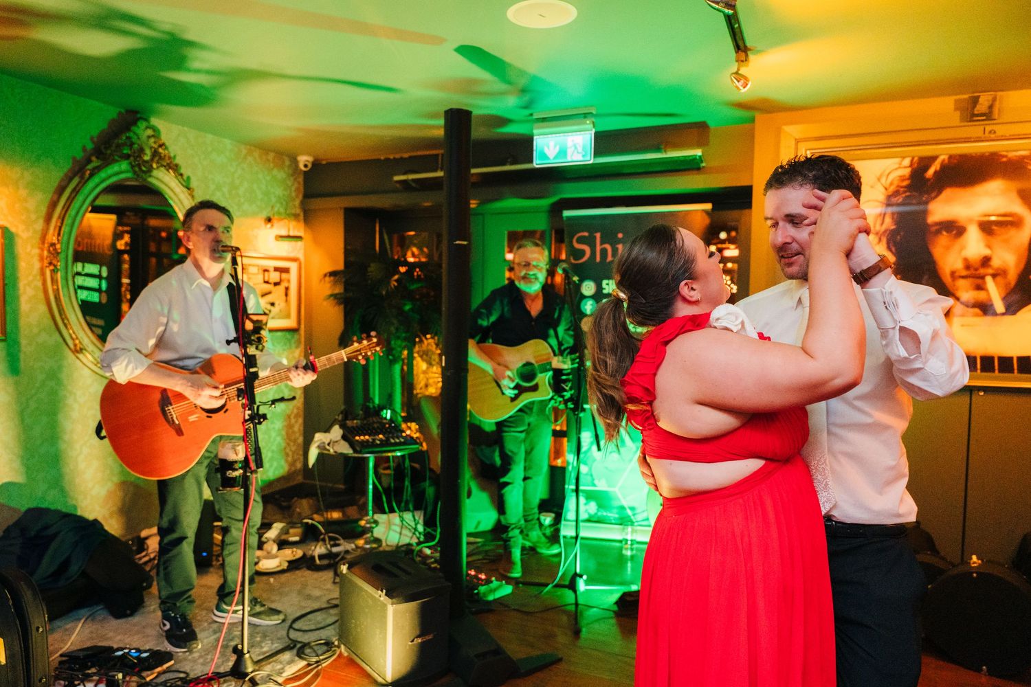 A live band performs while couples dance at a venue with green and yellow lighting. Marco Pierre Dublin Wedding Photographer