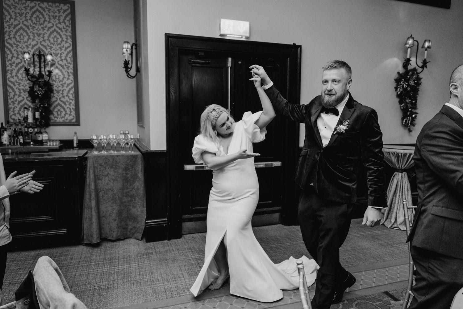 Wedding guests dancing together in black and white on a dimly lit dance floor. City Hall Dublin Photographer