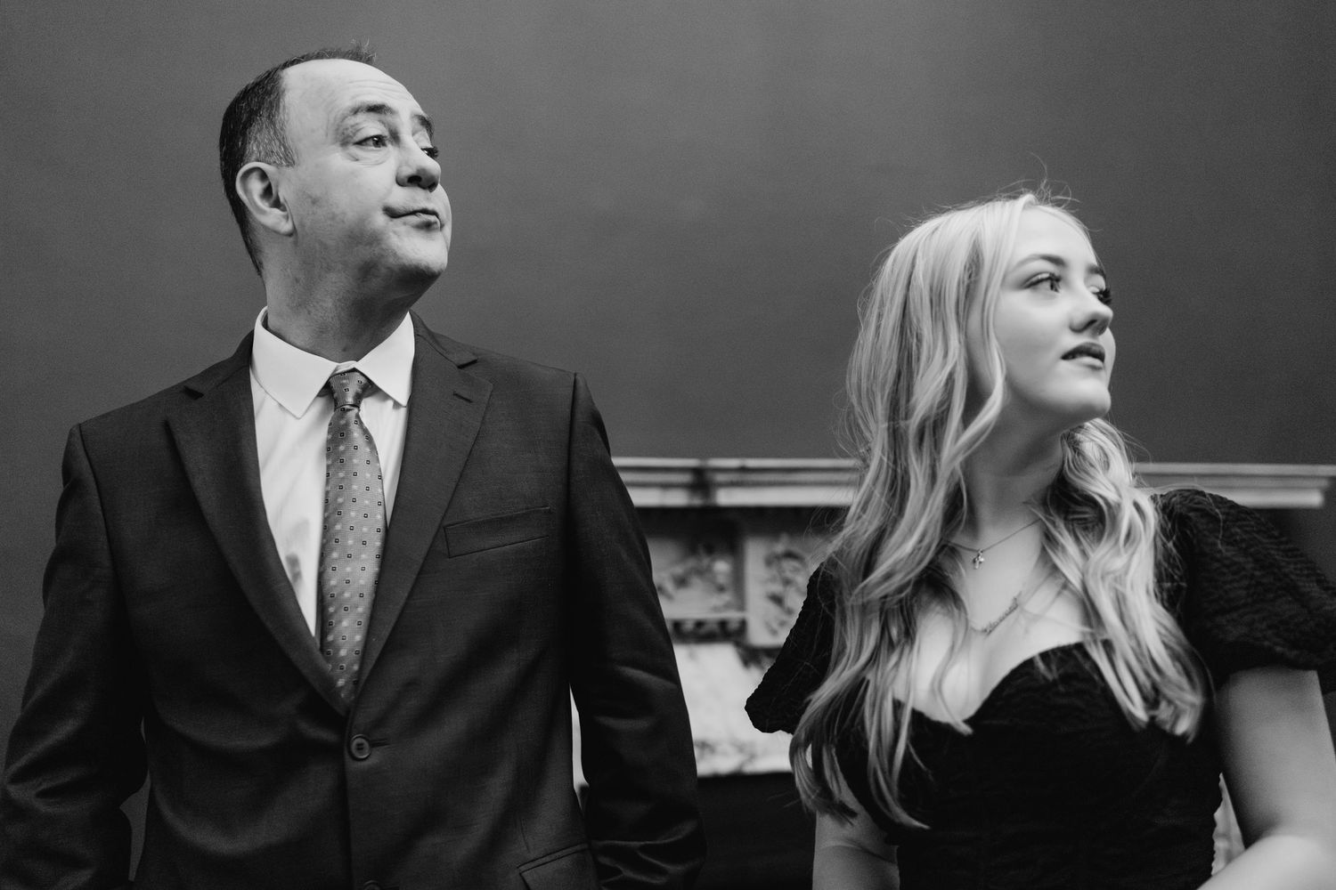 Two people in formal attire shown in black and white having a discussion in a professional setting.  Wedding PHOTOGRAPHER Dublin