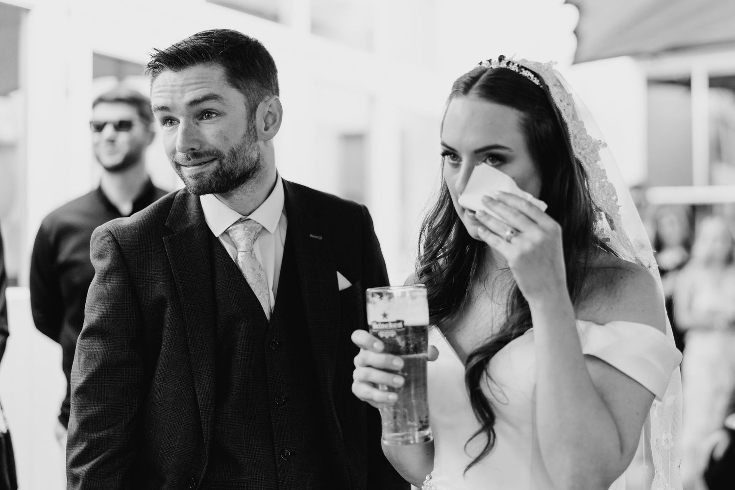 Poulaphouca Wedding photographer wicklow  Wedding party guests laugh and celebrate while raising their champagne glasses in celebration.
